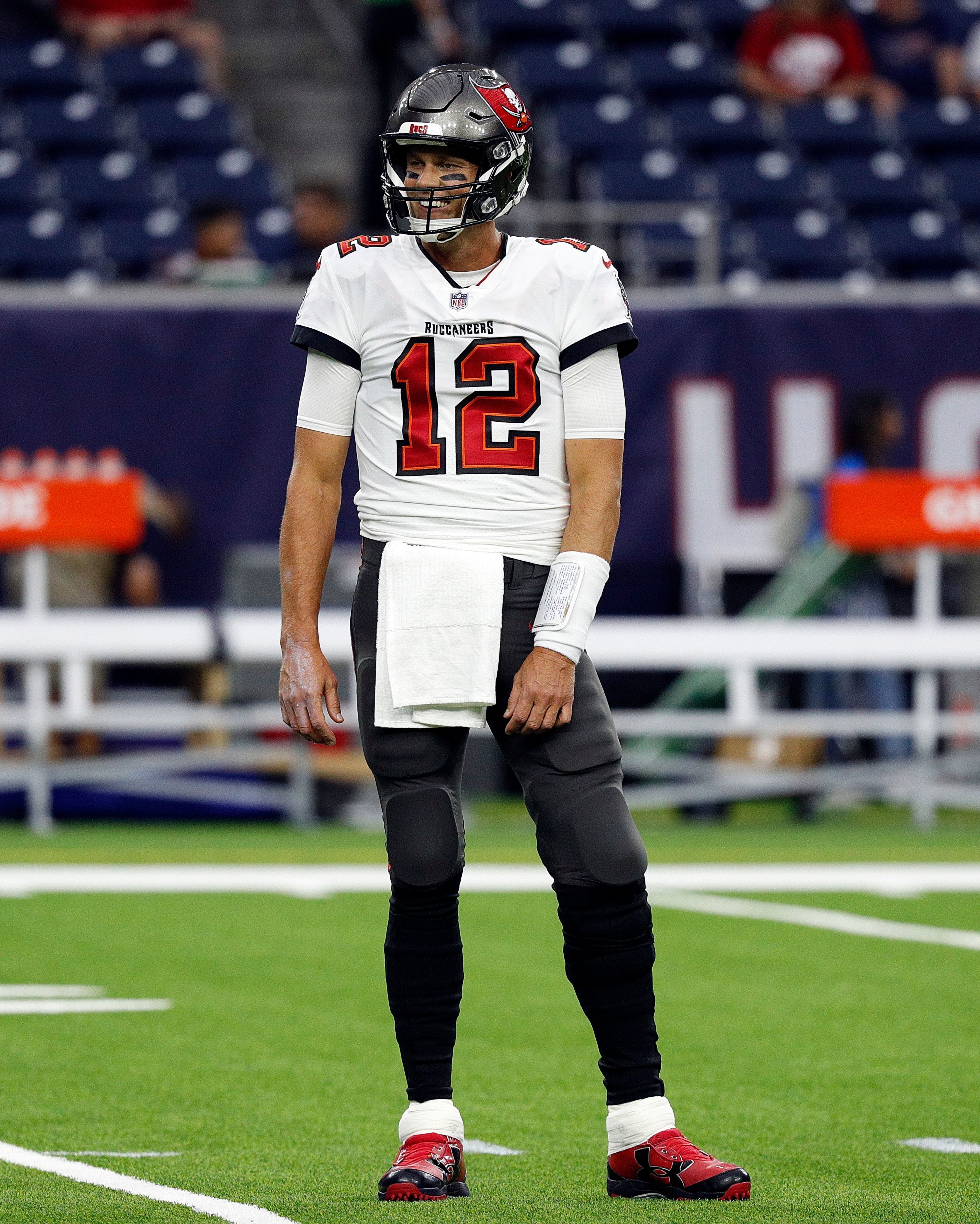 HOUSTON, TEXAS - AUGUST 28: Tom Brady #12 of the Tampa Bay Buccaneers looks on during warm ups before playing the Houston Texans in an NFL preseason game at NRG Stadium on August 28, 2021 in Houston, Texas. (Photo by Bob Levey/Getty Images)