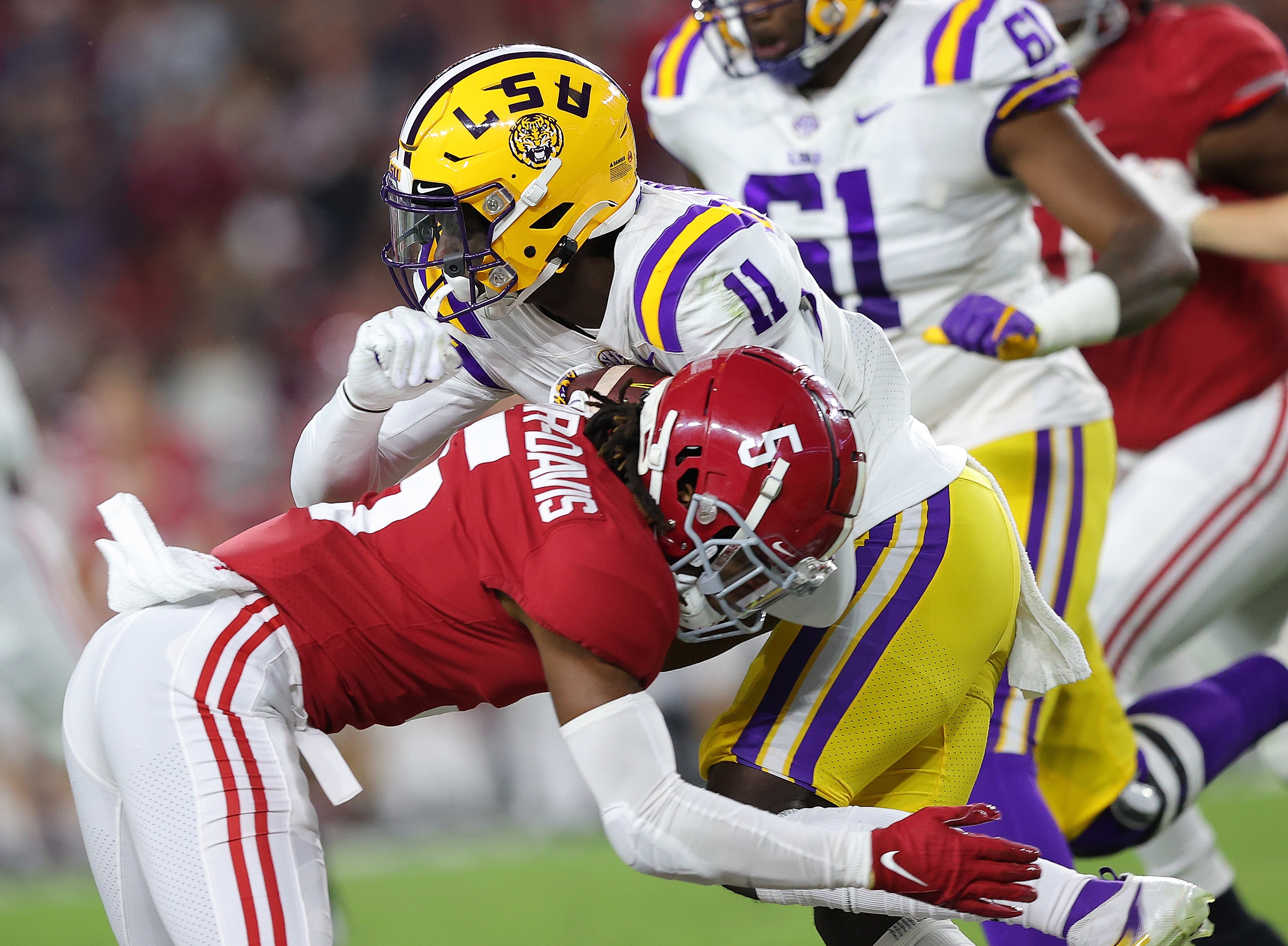 TUSCALOOSA, ALABAMA - NOVEMBER 06:  Jalyn Armour-Davis #5 of the Alabama Crimson Tide tackles Brian Thomas Jr. #11 of the LSU Tigers during the first half at Bryant-Denny Stadium on November 06, 2021 in Tuscaloosa, Alabama. (Photo by Kevin C. Cox/Getty Images)