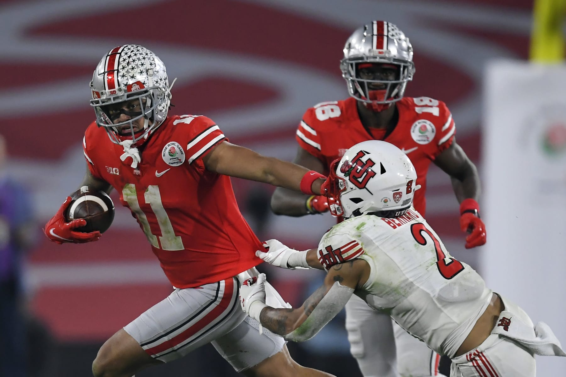 Ohio State wide receiver Jaxon Smith-Njigba (11) runs past Utah cornerback Kenzel Lawler (2) during the second half in the Rose Bowl NCAA college football game Saturday, Jan. 1, 2022, in Pasadena, Calif. (AP Photo/John McCoy)