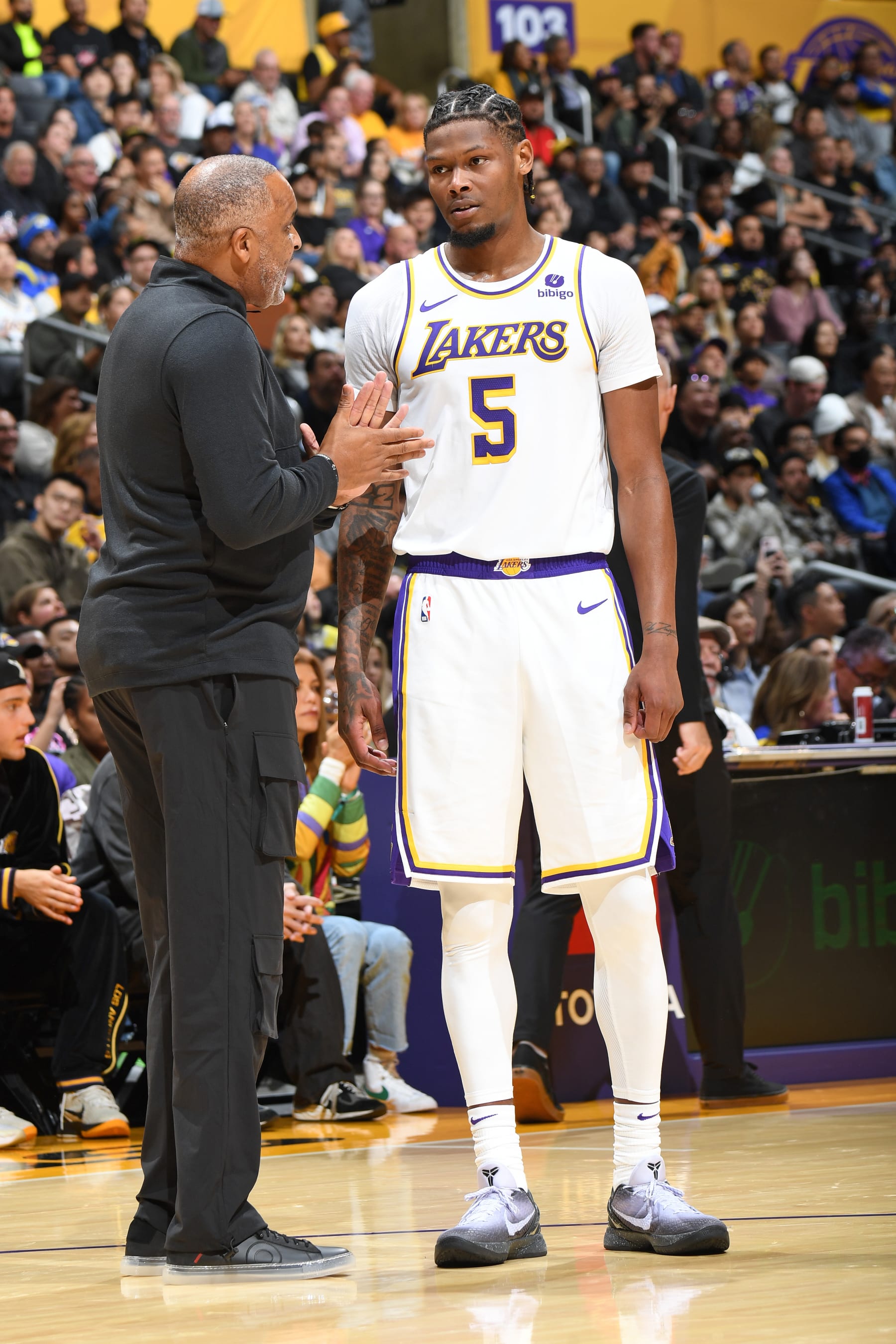 LOS ANGELES, CA - NOVEMBER 19: Assistant Coach Phil handy & Cam Reddish #5 of the Los Angeles Lakers looks on during the game on November 19, 2023 at Crypto.Com Arena in Los Angeles, California. NOTE TO USER: User expressly acknowledges and agrees that, by downloading and/or using this Photograph, user is consenting to the terms and conditions of the Getty Images License Agreement. Mandatory Copyright Notice: Copyright 2023 NBAE (Photo by Andrew D. Bernstein/NBAE via Getty Images)