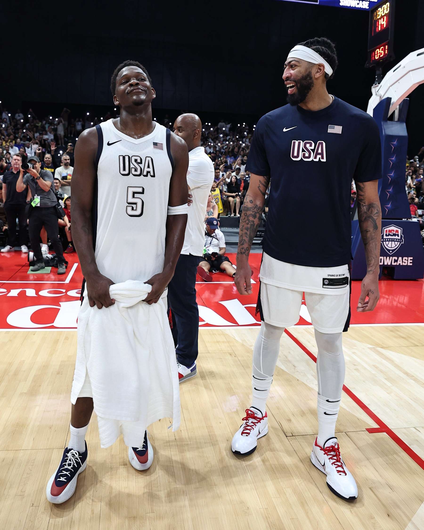 ABU DHABI, UAE - JULY 17: Anthony Edwards #5 of Team USA and Anthony Davis #14 of Team USA smile drives to the basket during the game against the Serbian Men's National Team during the 2024 USA Basketball Showcase on July 17, 2024 in Abu Dhabi, The United Arab Emirates at Etihad Arena. NOTE TO USER: User expressly acknowledges and agrees that, by downloading and/or using this Photograph, user is consenting to the terms and conditions of the Getty Images License Agreement. Mandatory Copyright Notice: Copyright 2024 NBAE (Photo by Jim Poorten/NBAE via Getty Images)