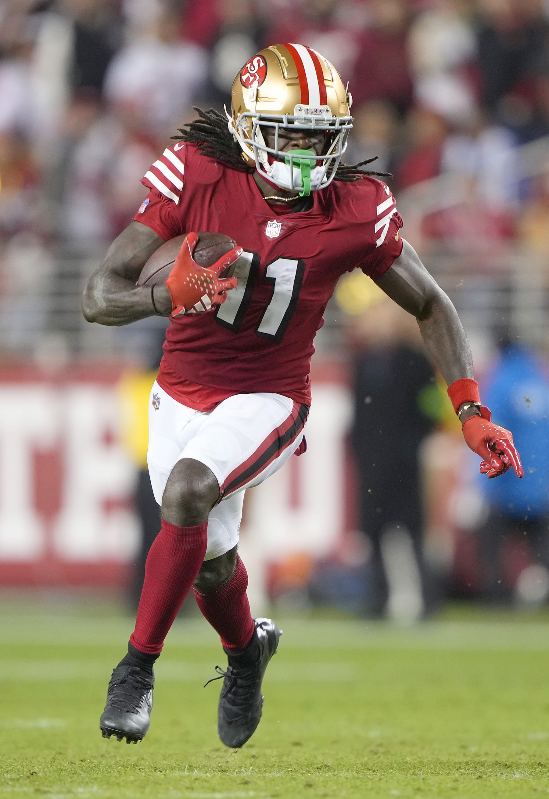 SANTA CLARA, CALIFORNIA - DECEMBER 25: Brandon Aiyuk #11 of the San Francisco 49ers runs with the ball after catching a pass against the Baltimore Ravens during the fourth quarter of an NFL football game at Levi's Stadium on December 25, 2023 in Santa Clara, California. (Photo by Thearon W. Henderson/Getty Images) SANTA CLARA, CALIFORNIA - DECEMBER 25: Brandon Aiyuk #11 of the San Francisco 49ers runs with the ball after catching a pass against the Baltimore Ravens during the fourth quarter of an NFL football game at Levi's Stadium on December 25, 2023 in Santa Clara, California. (Photo by Thearon W. Henderson/Getty Images)