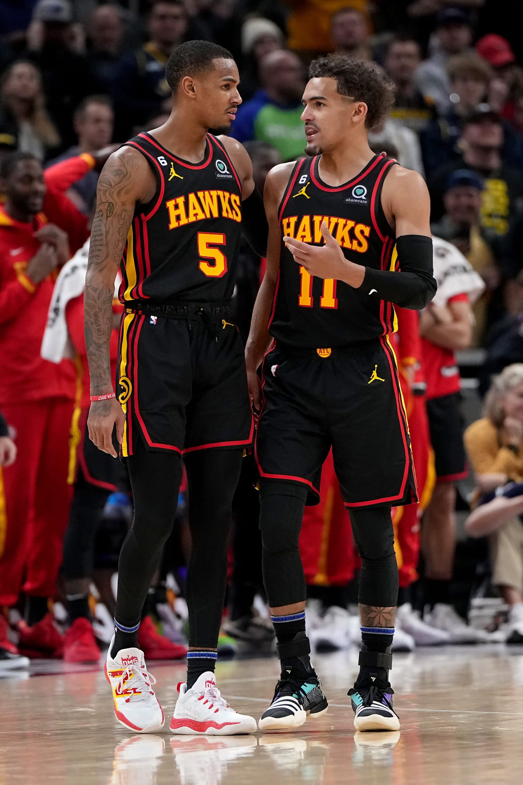 INDIANAPOLIS, INDIANA - JANUARY 13: Dejounte Murray #5 and Trae Young #11 of the Atlanta Hawks meet in the fourth quarter against the Indiana Pacers at Gainbridge Fieldhouse on January 13, 2023 in Indianapolis, Indiana. NOTE TO USER: User expressly acknowledges and agrees that, by downloading and or using this photograph, User is consenting to the terms and conditions of the Getty Images License Agreement. (Photo by Dylan Buell/Getty Images)