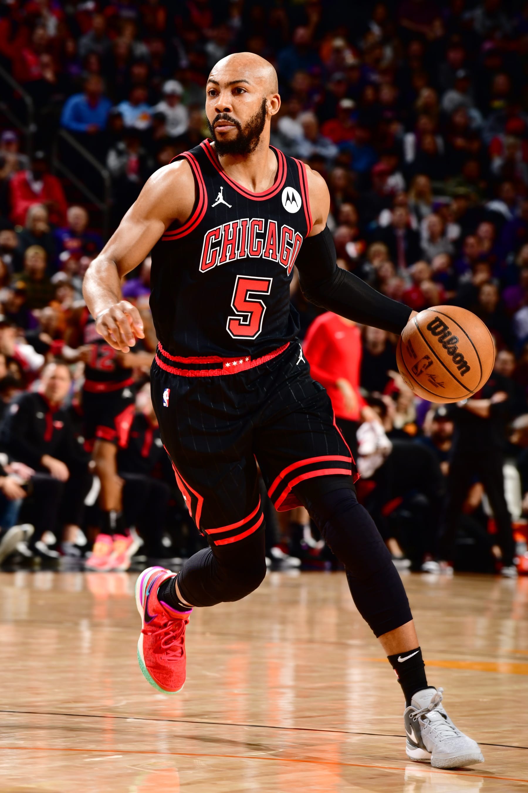 PHOENIX, AZ - JANUARY 22: Jevon Carter #5 of the Chicago Bulls dribbles the ball during the game against the Phoenix Suns on January 22, 2024 at Footprint Center in Phoenix, Arizona. NOTE TO USER: User expressly acknowledges and agrees that, by downloading and or using this photograph, user is consenting to the terms and conditions of the Getty Images License Agreement. Mandatory Copyright Notice: Copyright 2024 NBAE (Photo by Barry Gossage/NBAE via Getty Images)