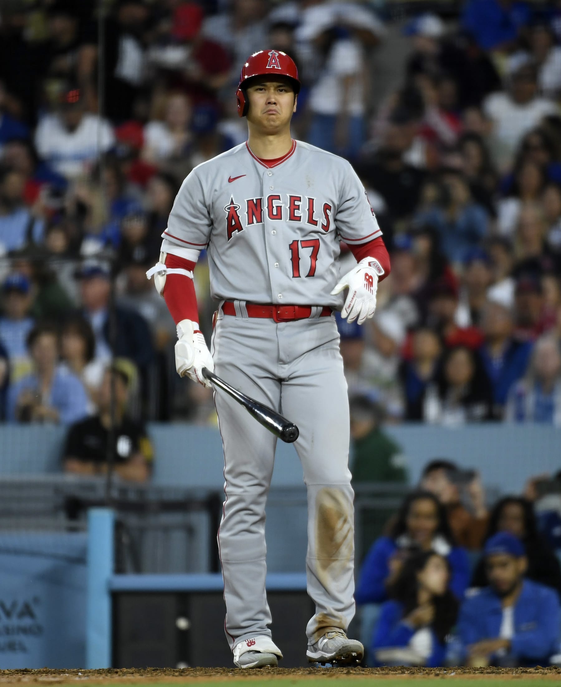 LOS ANGELES, CALIFORNIA - JULY 8: Shohei Ohtani #17 of the Los Angeles Angels grimaces as he shakes his left hand after hitting a foul ball before hitting a two run home run to score Andrew Velazquez #4 against pitcher pitcher Michael Grove #78 of the Los Angeles Dodgers during the seventh inning at Dodger Stadium on July 8, 2023 in Los Angeles, California. (Photo by Kevork Djansezian/Getty Images)