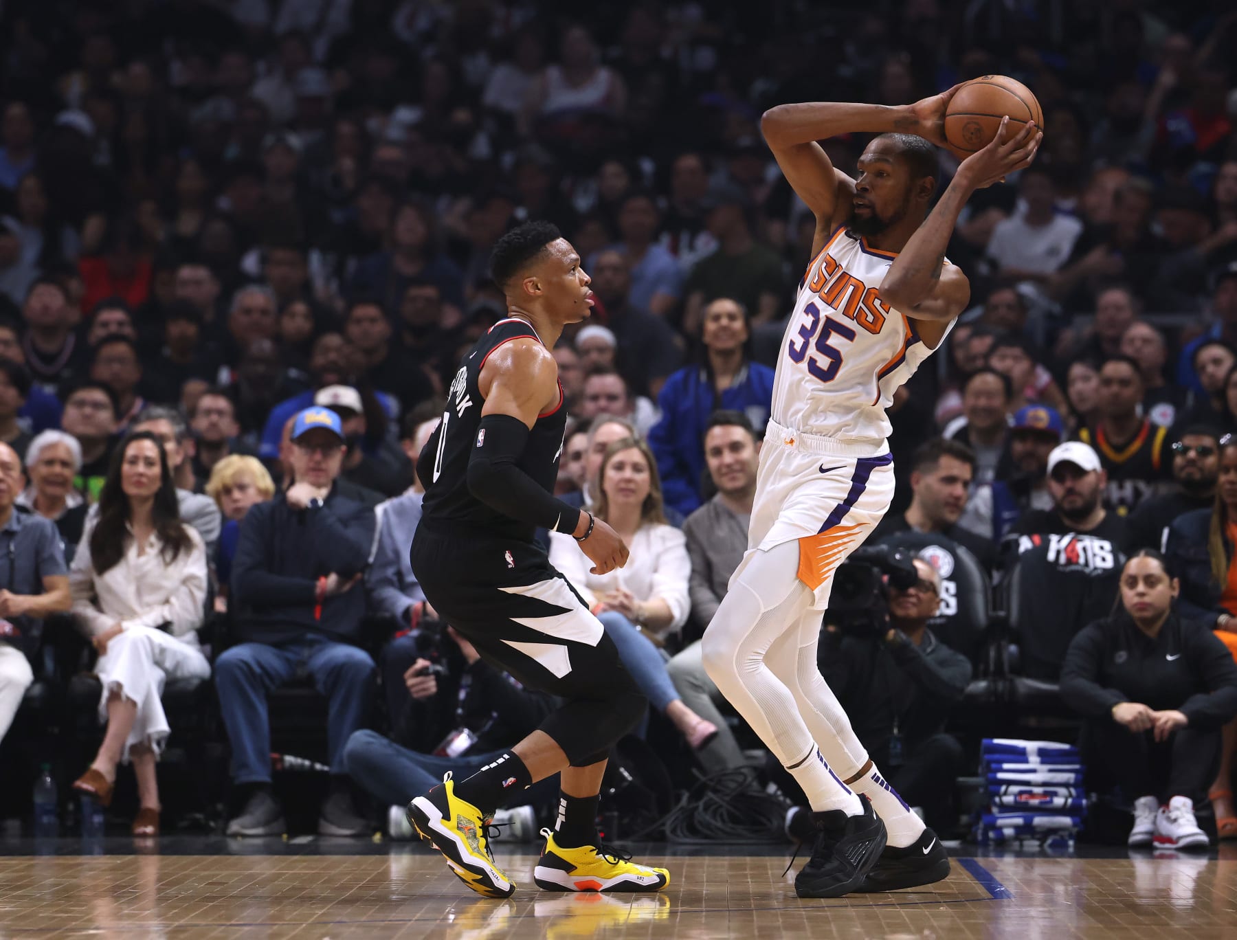 LOS ANGELES, CALIFORNIA - APRIL 22: Kevin Durant #35 of the Phoenix Suns keeps the ball away from Russell Westbrook #0 of the LA Clippers during the first quarter of Game Four of the Western Conference First Round Playoffs at Crypto.com Arena on April 22, 2023 in Los Angeles, California. NOTE TO USER: User expressly acknowledges and agrees that, by downloading and or using this photograph, User is consenting to the terms and conditions of the Getty Images License Agreement. (Photo by Harry How/Getty Images)