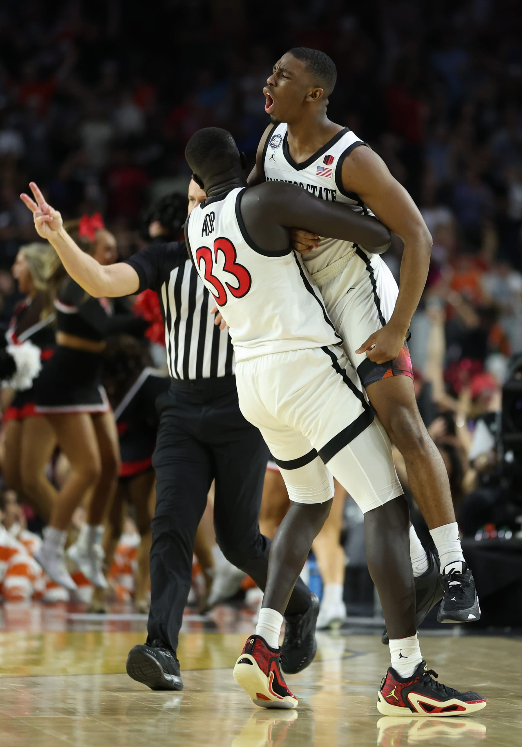 HOUSTON, TEXAS - APRIL 01: Lamont Butler #5 of the San Diego State Aztecs celebrates with Aguek Arop #33 after making a game winning basket to defeat the Florida Atlantic Owls 72-71 during the NCAA Men's Basketball Tournament Final Four semifinal game at NRG Stadium on April 01, 2023 in Houston, Texas. (Photo by Gregory Shamus/Getty Images)