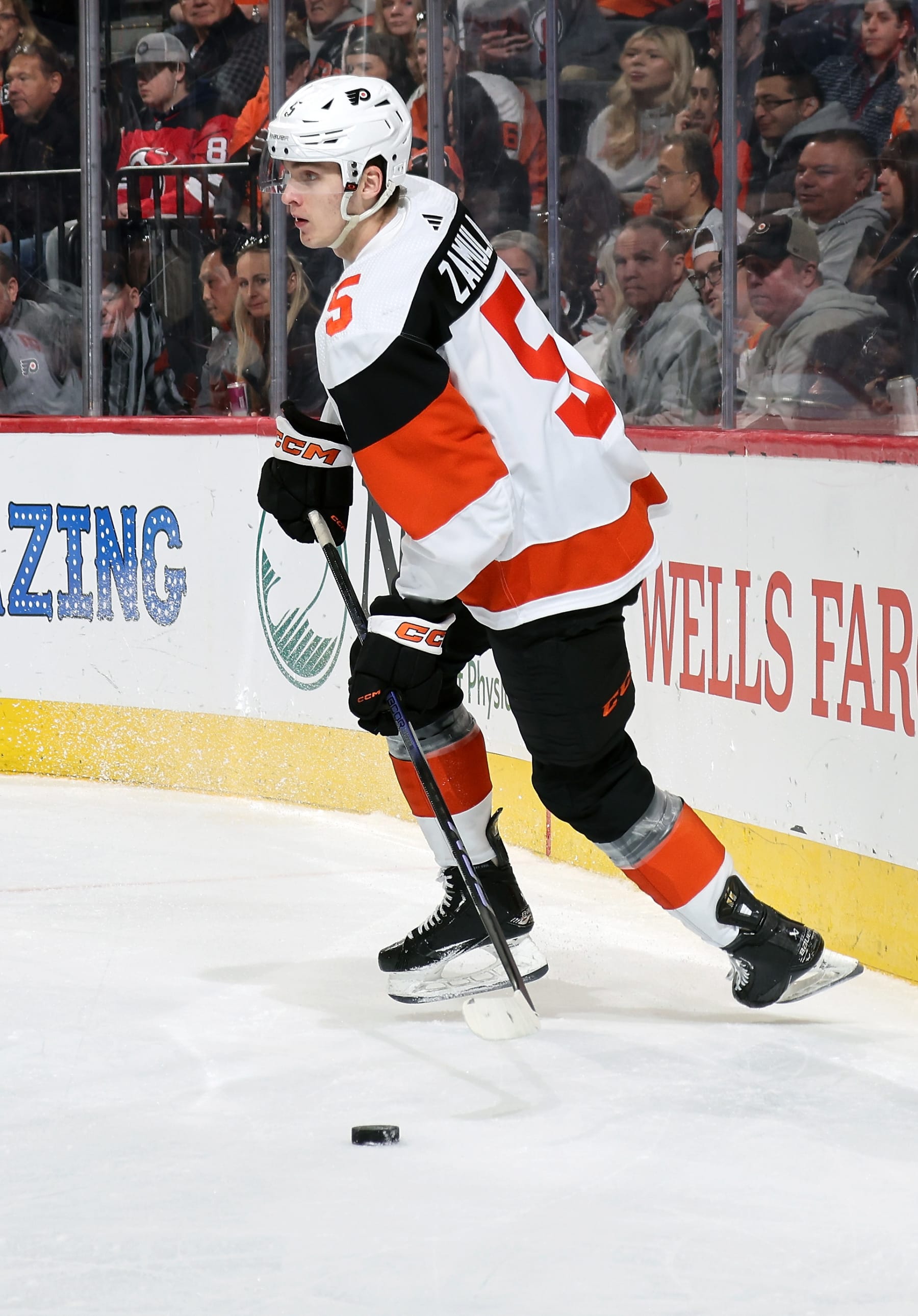 PHILADELPHIA, PENNSYLVANIA - APRIL 13:  Egor Zamula #5 of the Philadelphia Flyers skates the puck against the New Jersey Devils at the Wells Fargo Center on April 13, 2024 in Philadelphia, Pennsylvania.  (Photo by Len Redkoles/NHLI via Getty Images)