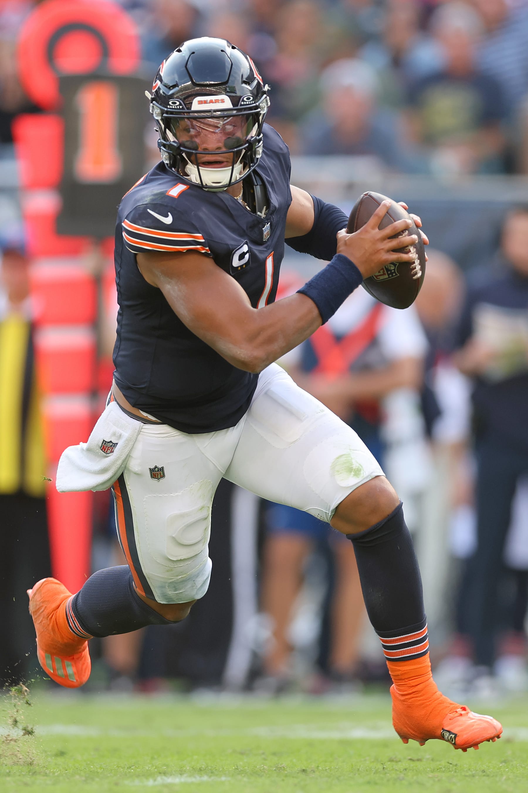 CHICAGO, ILLINOIS - SEPTEMBER 10: Justin Fields #1 of the Chicago Bears scrambles with the ball against the Green Bay Packers during the third quarter at Soldier Field on September 10, 2023 in Chicago, Illinois. (Photo by Michael Reaves/Getty Images)
