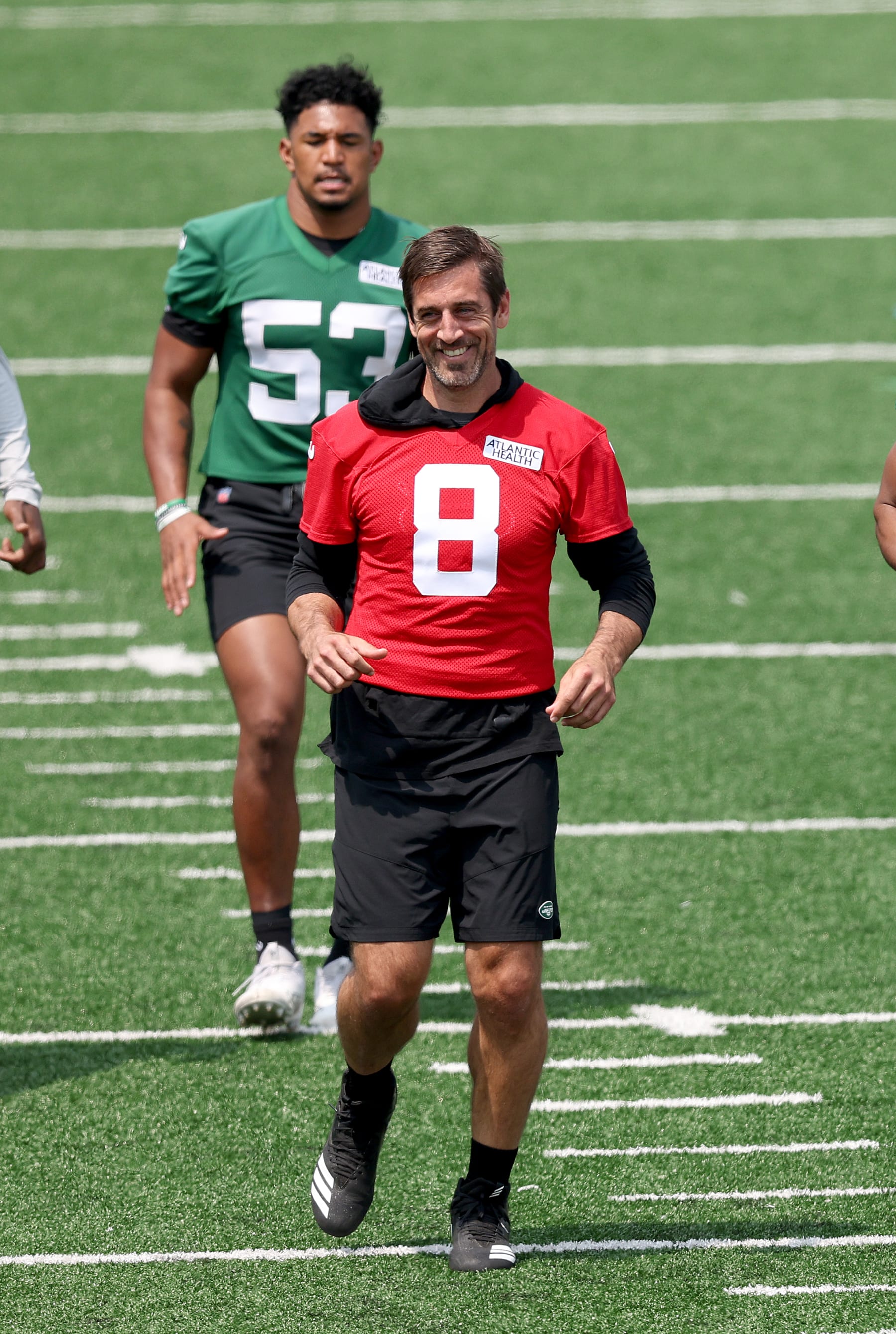 FLORHAM PARK, NEW JERSEY - MAY 23: Aaron Rodgers #8 and Zaire Barnes #43 of the New York Jets warm up during an offseason workout session at Atlantic Health Jets Training Center on May 23, 2023 in Florham Park, New Jersey. (Photo by Elsa/Getty Images)