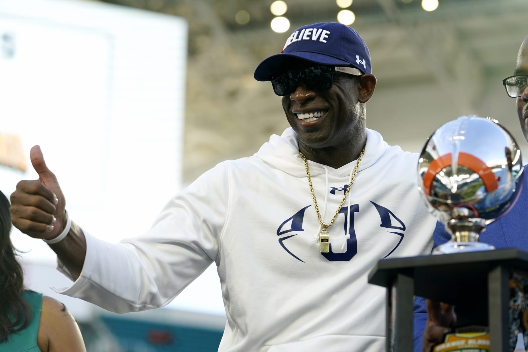 Jackson State head coach Deion Sanders poses with the trophy after the Orange Blossom Classic NCAA college football game against against Florida A&M, Sunday, Sept. 4, 2022, in Miami Gardens, Fla. (AP Photo/Lynne Sladky)