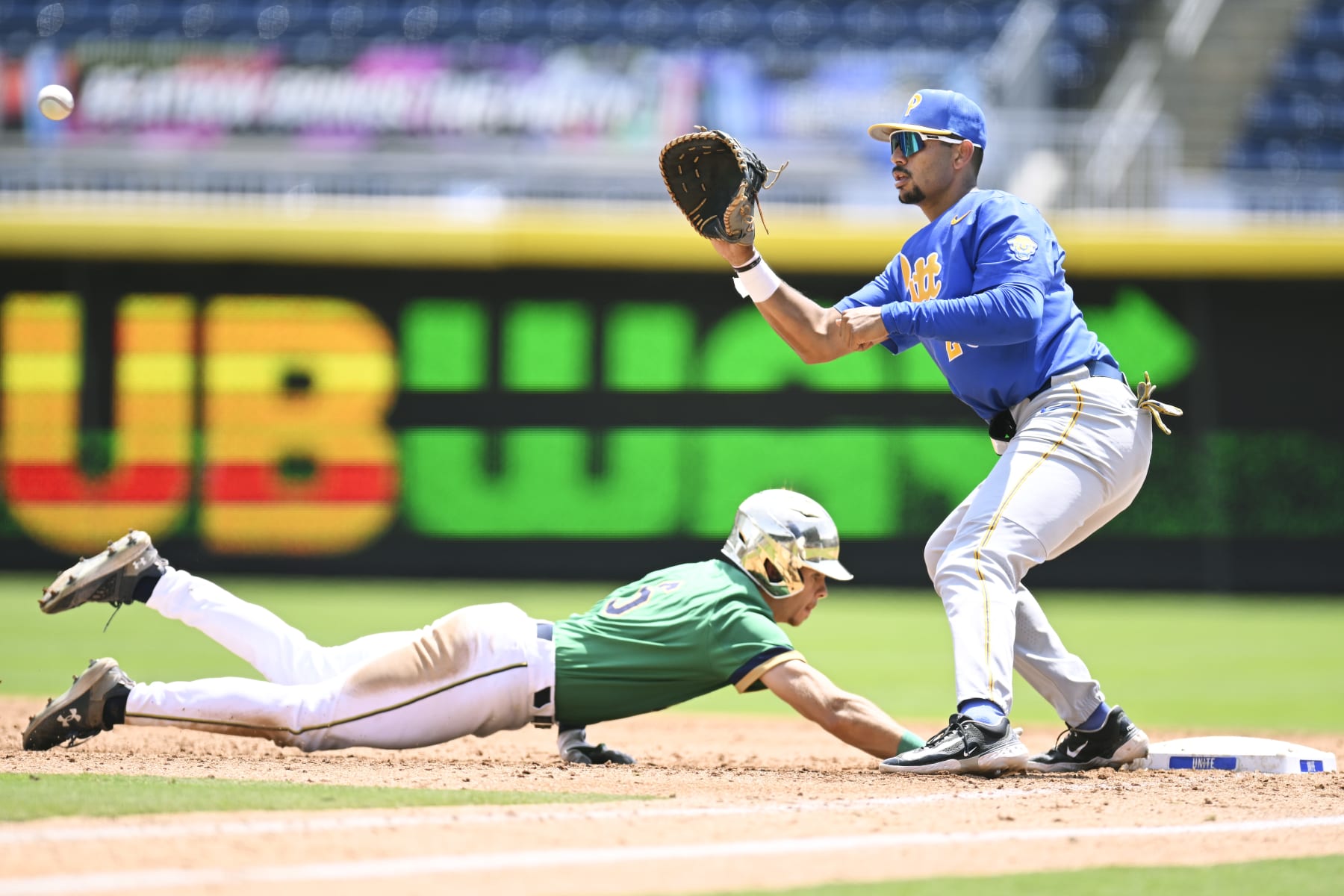 DURHAM, NORTH CAROLINA - MAY 24: TJ Williams #6 of the Notre Dame Fighting Irish slides safely back to first base against Noah Martinez #23 of the Pittsburgh Panthers in the fourth inning during the ACC Baseball Championship at Durham Bulls Athletic Park on May 24, 2023 in Durham, North Carolina. (Photo by Eakin Howard/Getty Images)