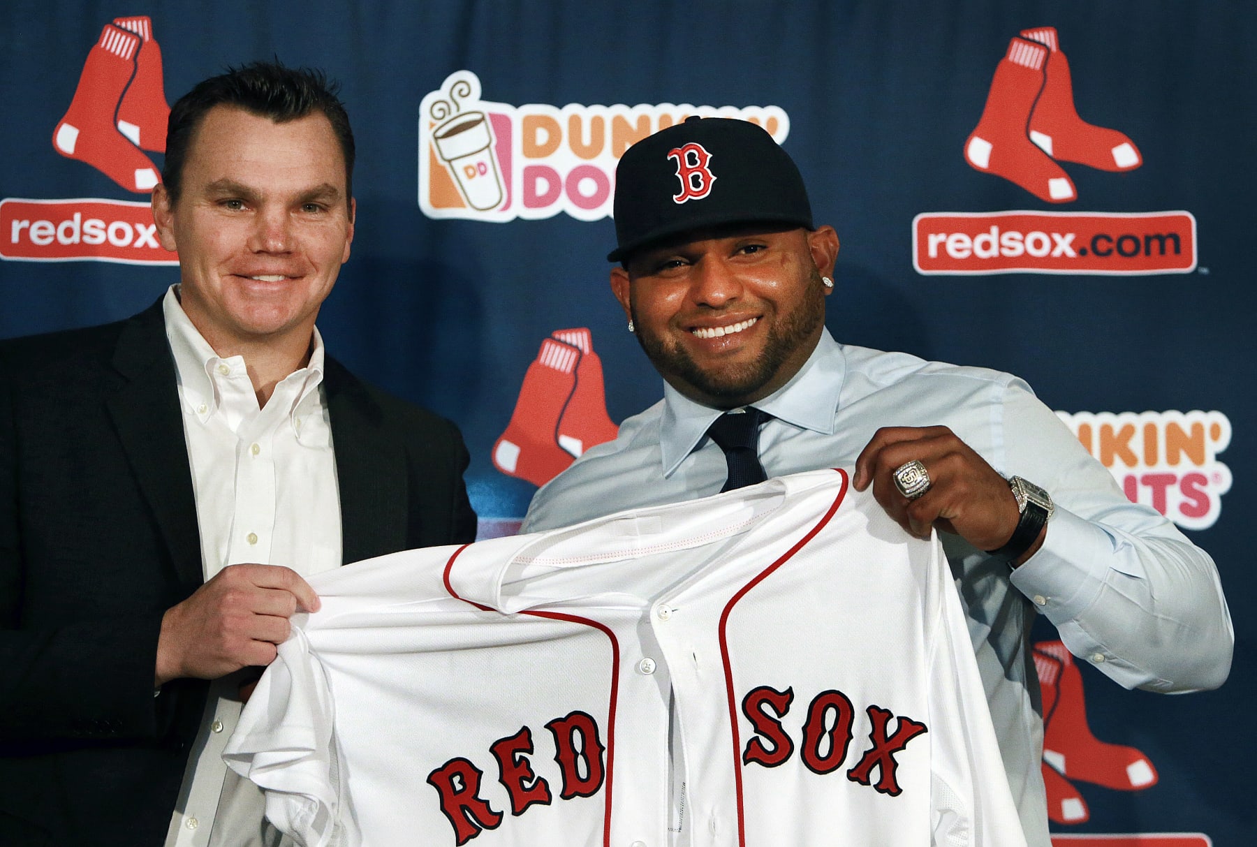 BOSTON - NOVEMBER 25: The Boston Red Sox introduced newly signed third baseman Pablo Sandoval, right, at a press conference at Fenway Park. Sandoval holding up his new jersey with general manager Ben Cherington, left. A World Series ring from his days with the San Francisco Giants is on his left hand. (Photo by Jim Davis/The Boston Globe via Getty Images)