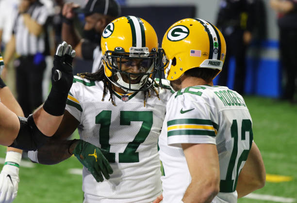 DETROIT, MICHIGAN - DECEMBER 13: Aaron Rodgers #12 of the Green Bay Packers celebrates rushing for a touchdown with Davante Adams #17 of the Green Bay Packers during the third quarter against the Detroit Lions at Ford Field on December 13, 2020 in Detroit, Michigan. (Photo by Rey Del Rio/Getty Images)