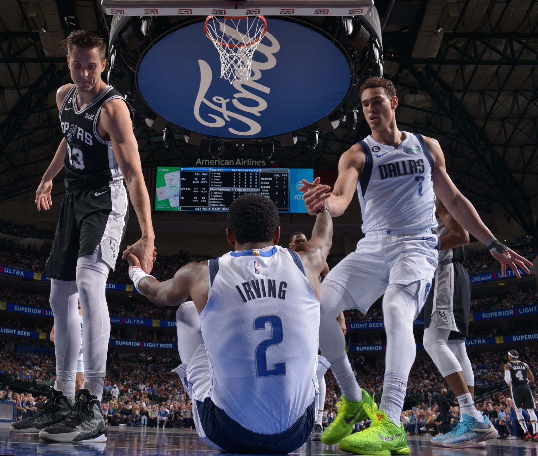 DALLAS, TX - FEBRUARY 23: Kyrie Irving #2 of the Dallas Mavericks is helped up by teammate Dwight Powell #7 and opponent Zach Collins #23 of the San Antonio Spurs during the game on February 23, 2023 at the American Airlines Center in Dallas, Texas. NOTE TO USER: User expressly acknowledges and agrees that, by downloading and or using this photograph, User is consenting to the terms and conditions of the Getty Images License Agreement. Mandatory Copyright Notice: Copyright 2023 NBAE (Photo by Glenn James/NBAE via Getty Images)
