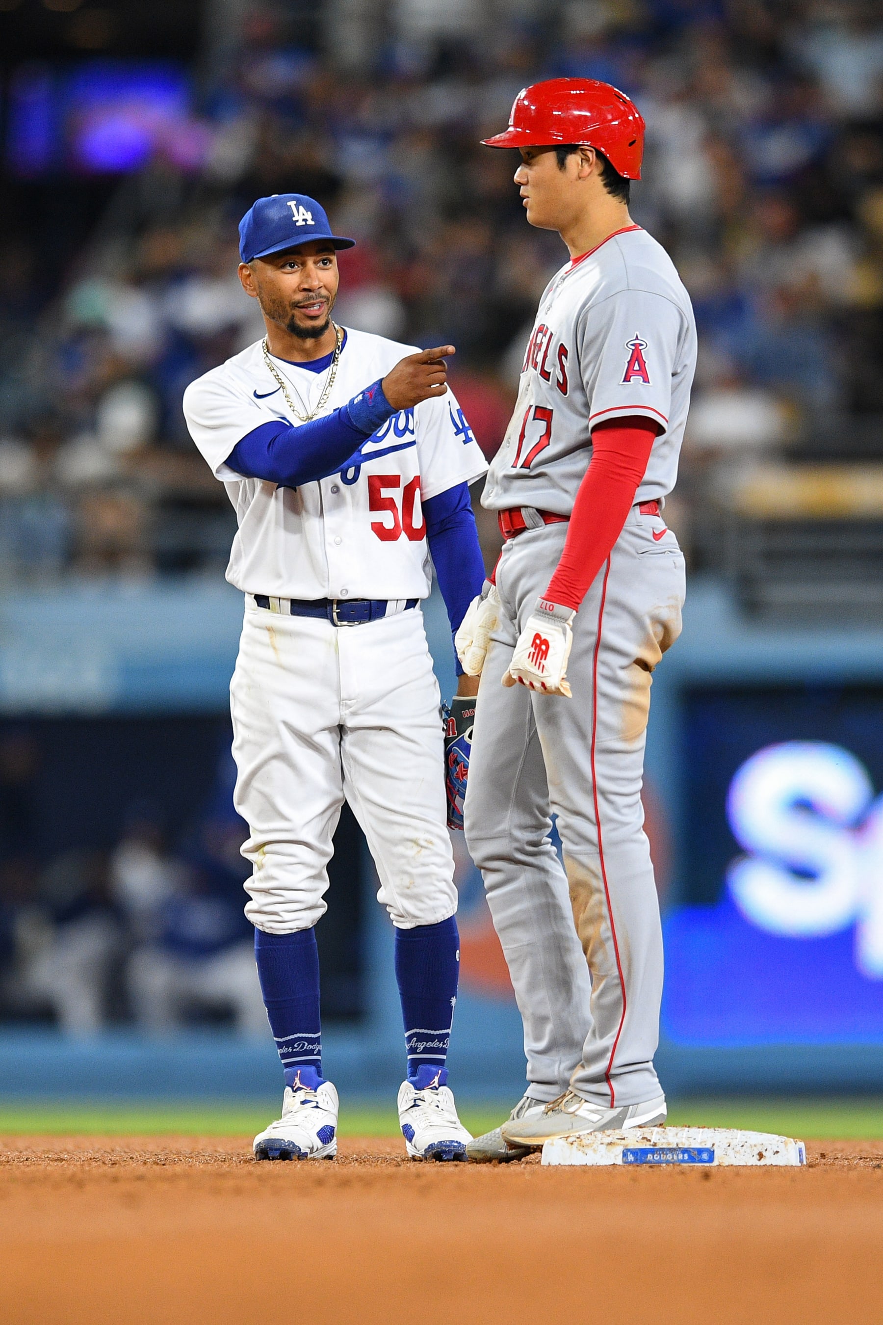 LOS ANGELES, CA - JULY 07: Los Angeles Dodgers second baseman Mookie Betts (50) jokes with Los Angeles Angels designated hitter Shohei Ohtani (17) during the MLB game between the Los Angeles Angels and the Los Angeles Dodgers on July 7, 2023 at Dodger Stadium in Los Angeles, CA. (Photo by Brian Rothmuller/Icon Sportswire via Getty Images)