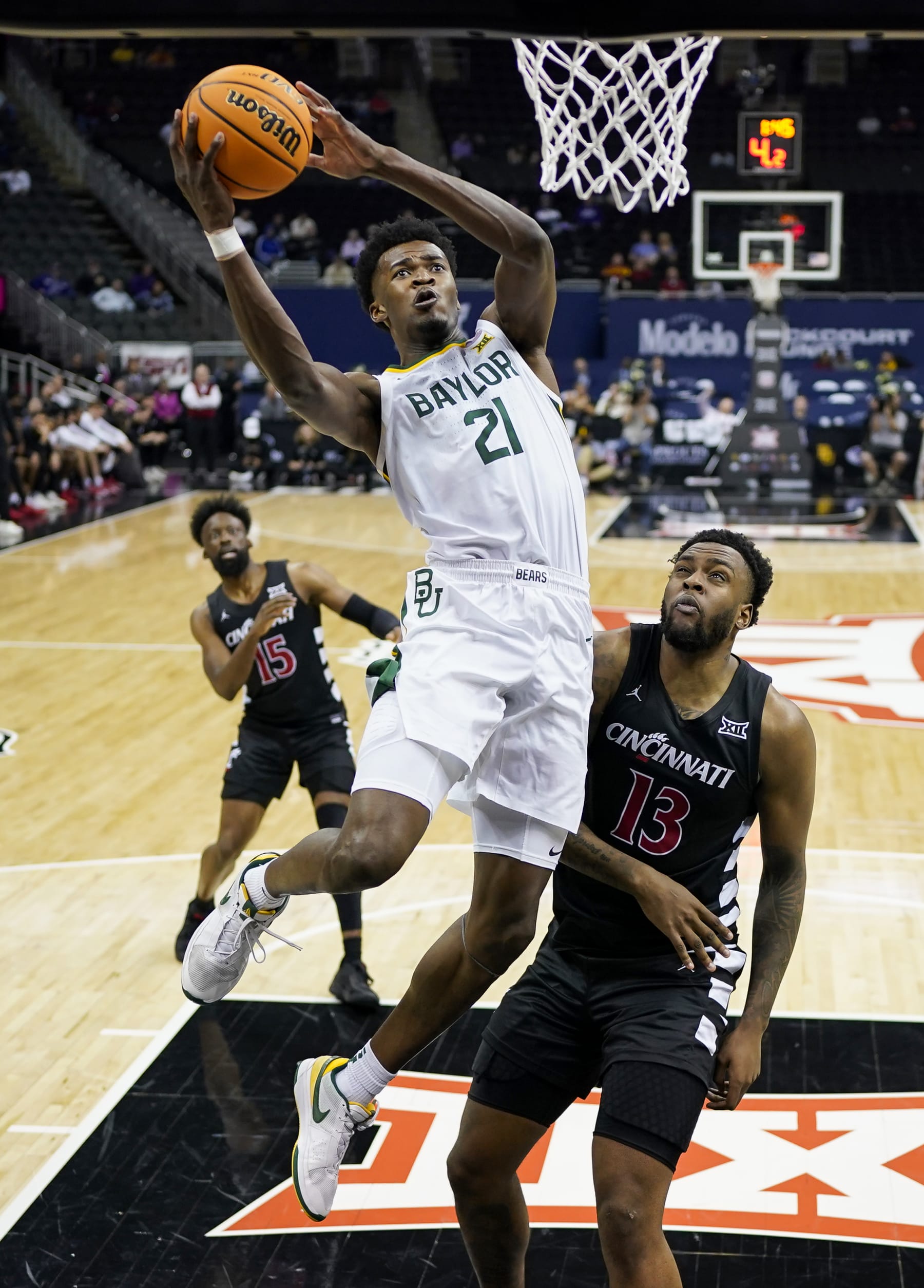 KANSAS CITY, MISSOURI - MARCH 14: Yves Missi #21 of the Baylor Bears shoots against Jamille Reynolds #13 of the Cincinnati Bearcats during the second half of a quarterfinal game of the Big 12 Men's Basketball Tournament at T-Mobile Center on March 14, 2024 in Kansas City, Missouri.  (Photo by Jay Biggerstaff/Getty Images)