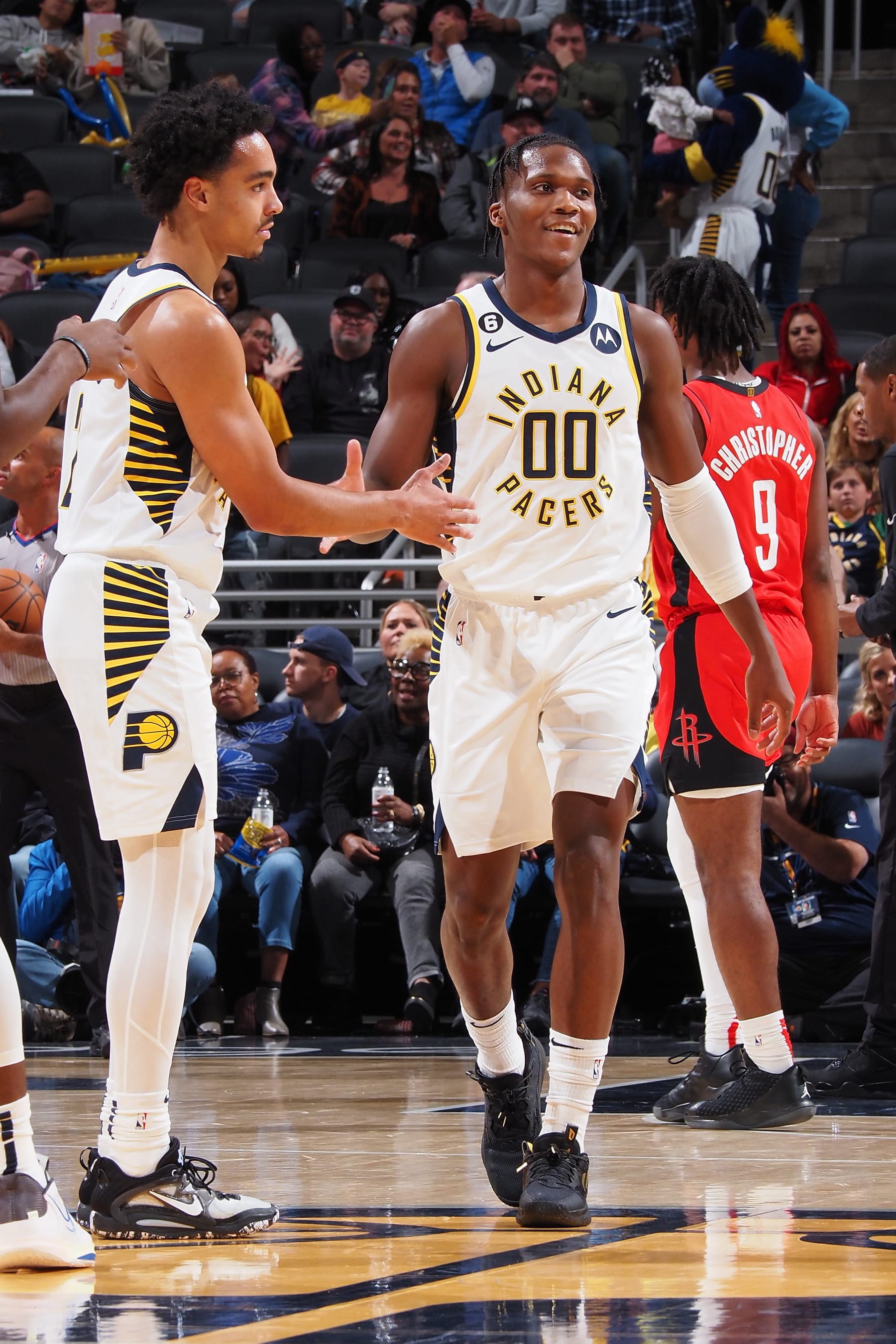 INDIANAPOLIS, IN - OCTOBER 14: Bennedict Mathurin #00 of the Indiana Pacers high-fives Andrew Nembhard #2 during a preseason game against the Houston Rockets on October 14, 2022 at Gainsbridge Fieldhouse in Indianapolis, Indiana. NOTE TO USER: User expressly acknowledges and agrees that, by downloading and or using this Photograph, user is consenting to the terms and conditions of the Getty Images License Agreement. Mandatory Copyright Notice: Copyright 2022 NBAE (Photo by Ron Hoskins/NBAE via Getty Images)