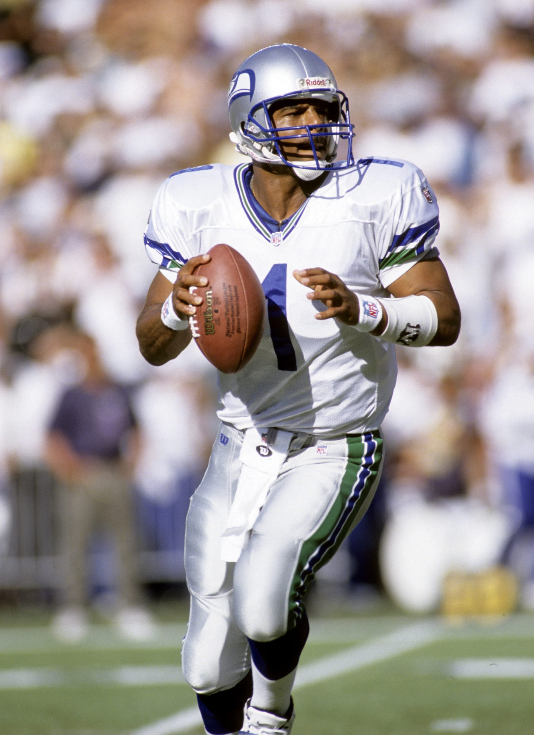 Hall of Fame quarterback Warren Moon of the Seattle Seahawks looks for an open receiver during a 37-31 victory over the San Diego Chargers on November 9, 1997 at Qualcomm Stadium in San Diego, California. (Photo by Peter Brouillet/Getty Images)