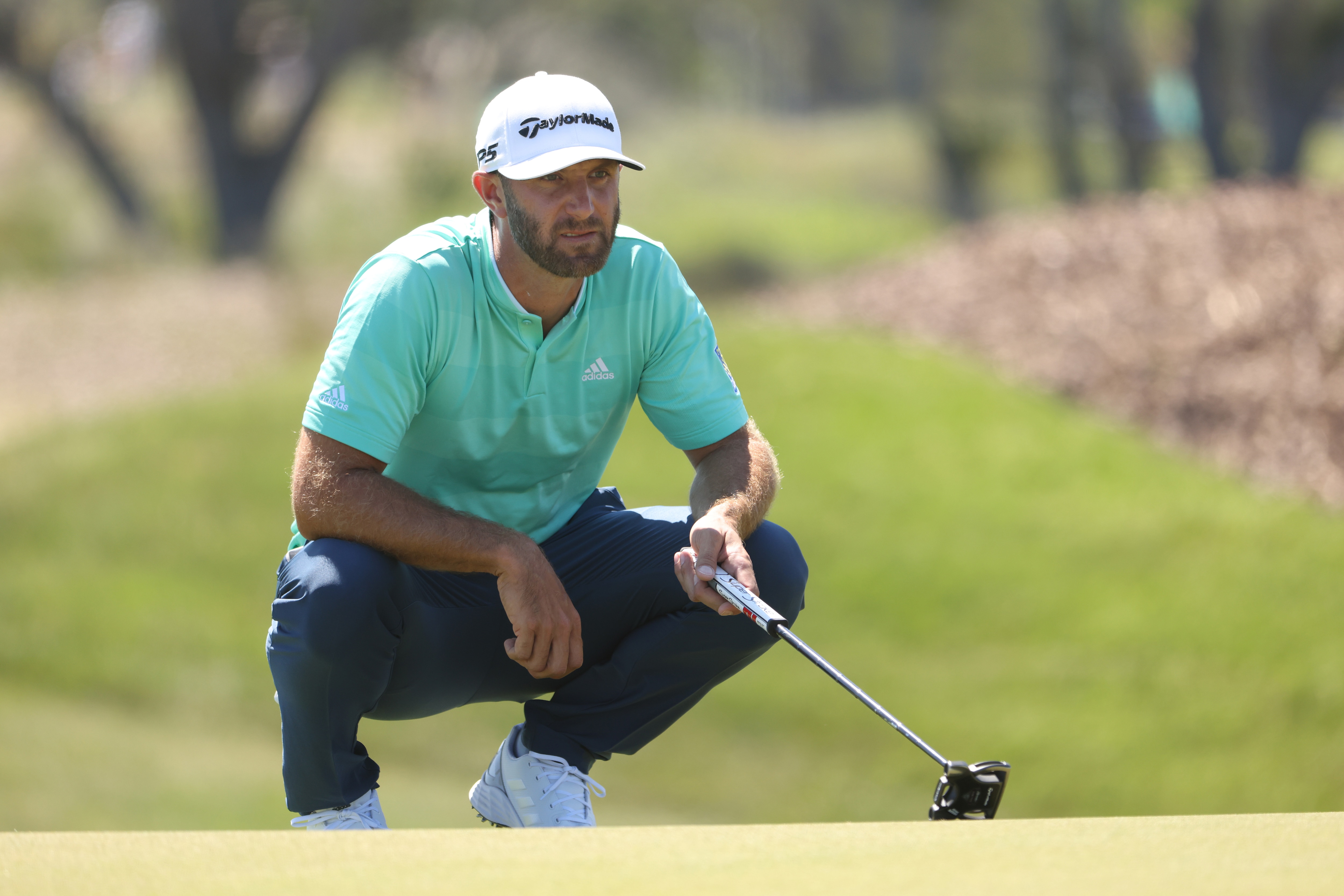 KIAWAH ISLAND, SOUTH CAROLINA - MAY 20: Dustin Johnson of the United States lines up a putt on the third green during the first round of the 2021 PGA Championship at Kiawah Island Resort's Ocean Course on May 20, 2021 in Kiawah Island, South Carolina. (Photo by Jamie Squire/Getty Images)