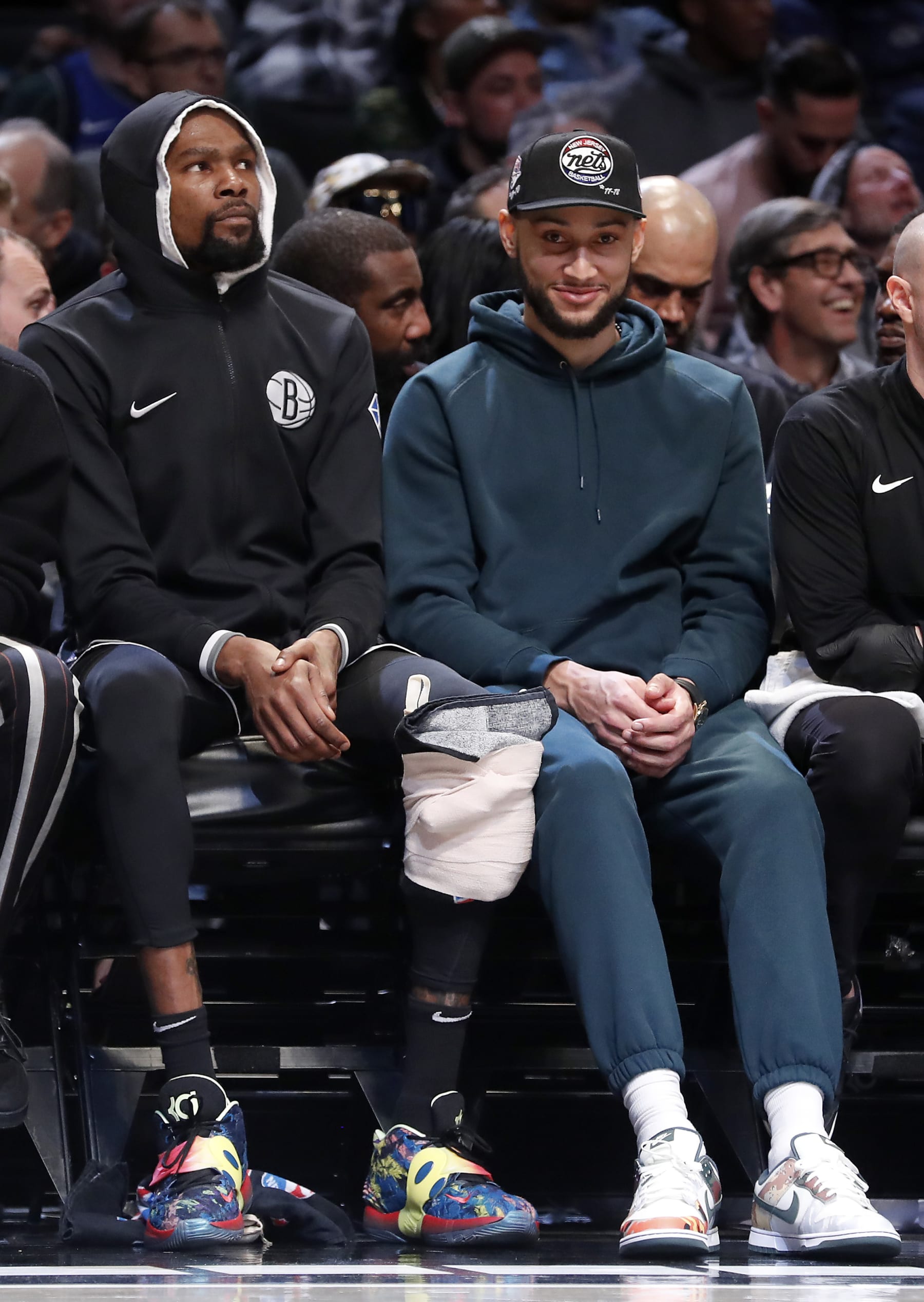 NEW YORK, NEW YORK - MARCH 16: (NEW YORK DAILIES OUT)  Kevin Durant #7 (L) and Ben Simmons #10 of the Brooklyn Nets look on against the Dallas Mavericks at Barclays Center on March 16, 2022 in New York City. The Mavericks defeated the Nets 113-111. NOTE TO USER: User expressly acknowledges and agrees that, by downloading and or using this photograph, User is consenting to the terms and conditions of the Getty Images License Agreement. (Photo by Jim McIsaac/Getty Images)