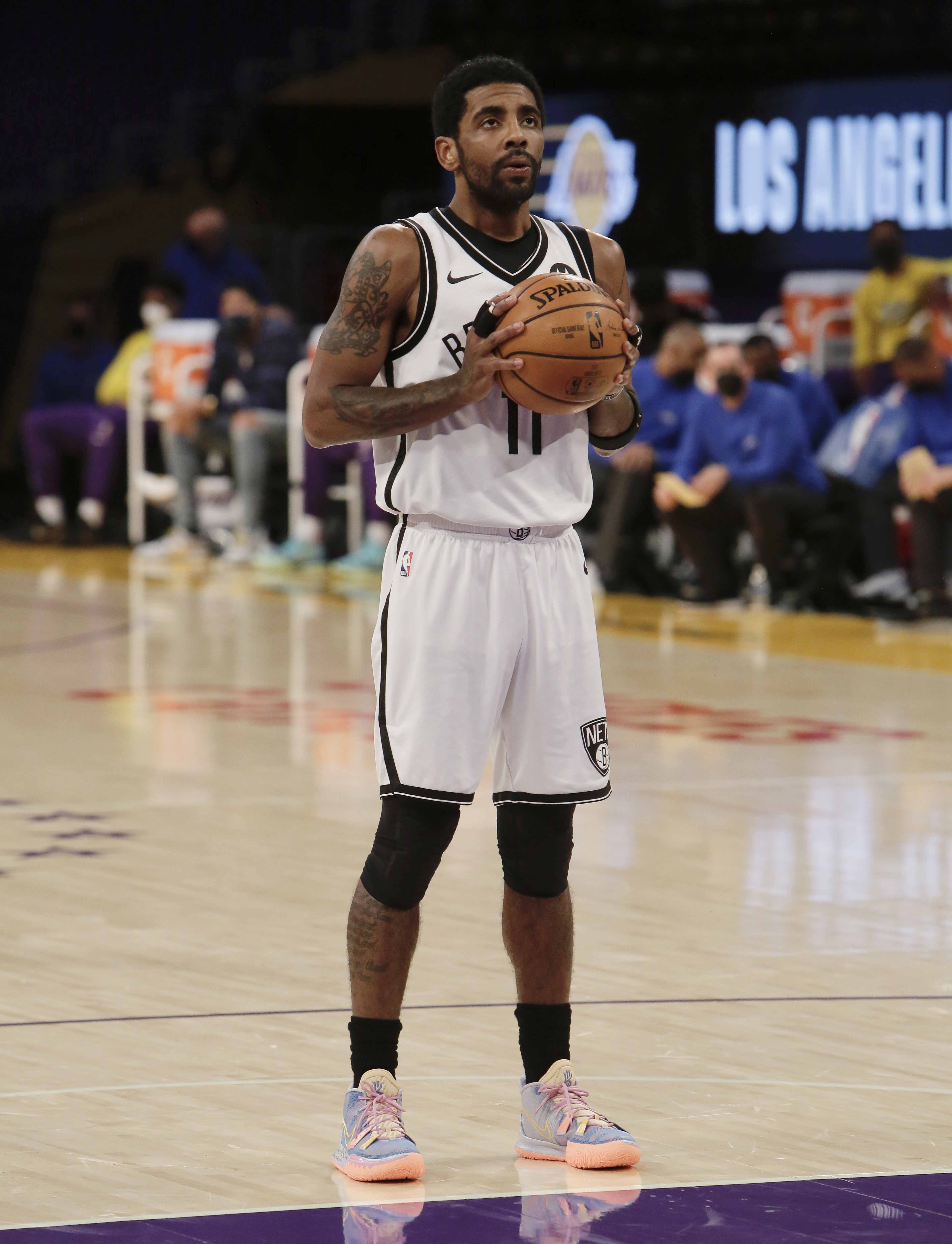 LOS ANGELES, CA - FEBRUARY 18: Kyrie Irving #11 of the Brooklyn Nets shoots a free throw during the game against the Los Angeles Lakers on February 18, 2021 at STAPLES Center in Los Angeles, California. NOTE TO USER: User expressly acknowledges and agrees that, by downloading and/or using this photograph, user is consenting to the terms and conditions of the Getty Images License Agreement.  Mandatory Copyright Notice: Copyright 2021 NBAE (Photo by Jim Poorten/NBAE via Getty Images)