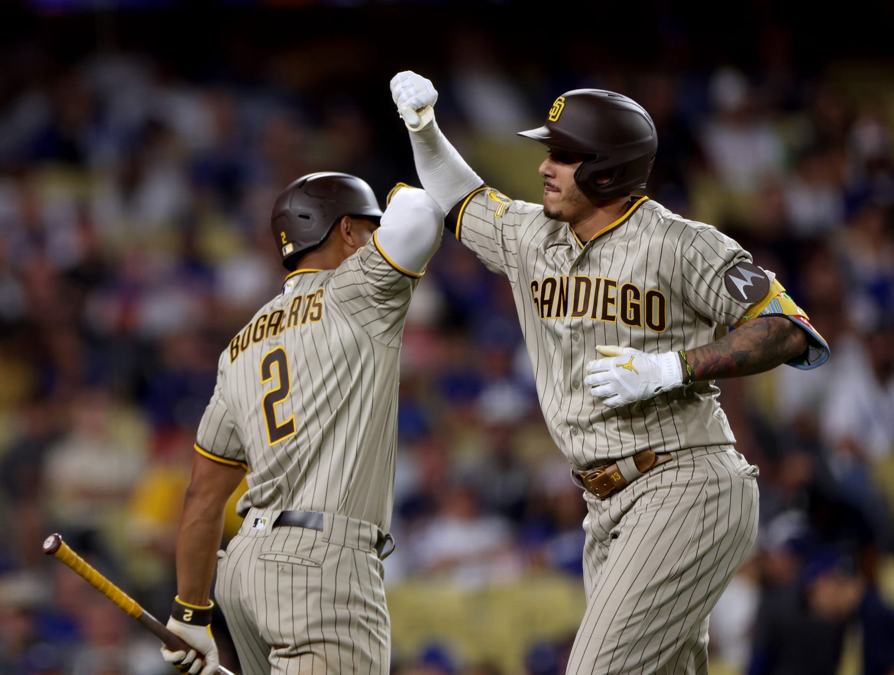 LOS ANGELES, CALIFORNIA - SEPTEMBER 11: Manny Machado #13 of the San Diego Padres celebrates his two run home run with Xander Bogaerts #2, to trail 7-6 to the Los Angeles Dodgers, during the sixth inning at Dodger Stadium on September 11, 2023 in Los Angeles, California. (Photo by Harry How/Getty Images)