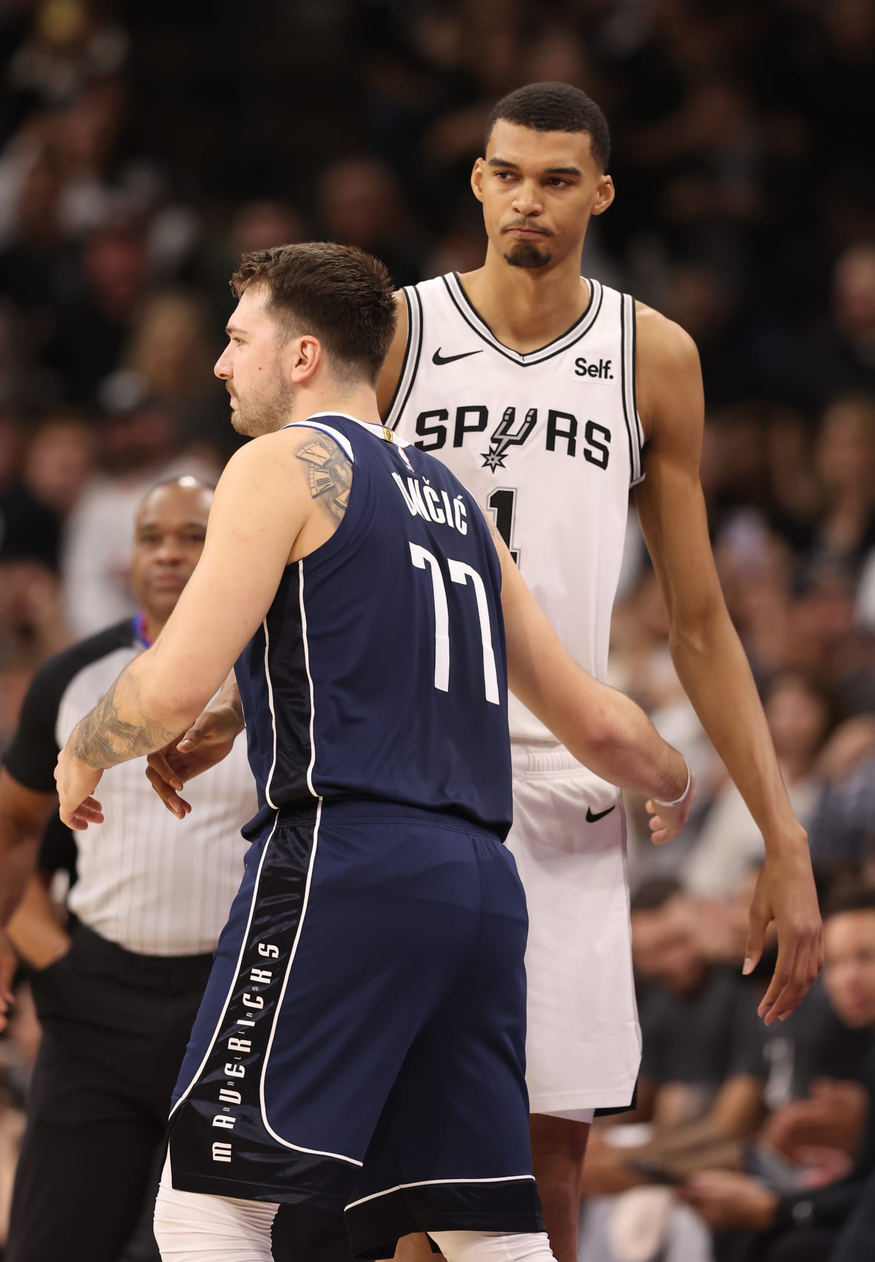 SAN ANTONIO, TEXAS - OCTOBER 25: Victor Wembanyama #1 of the San Antonio Spurs and Luka Doncic #77 of the Dallas Mavericks talk prior to tip off at Frost Bank Center on October 25, 2023 in San Antonio, Texas. NOTE TO USER: User expressly acknowledges and agrees that, by downloading and/or using this Photograph, user is consenting to the terms and conditions of the Getty Images License Agreement. (Photo by Christian Petersen/Getty Images)