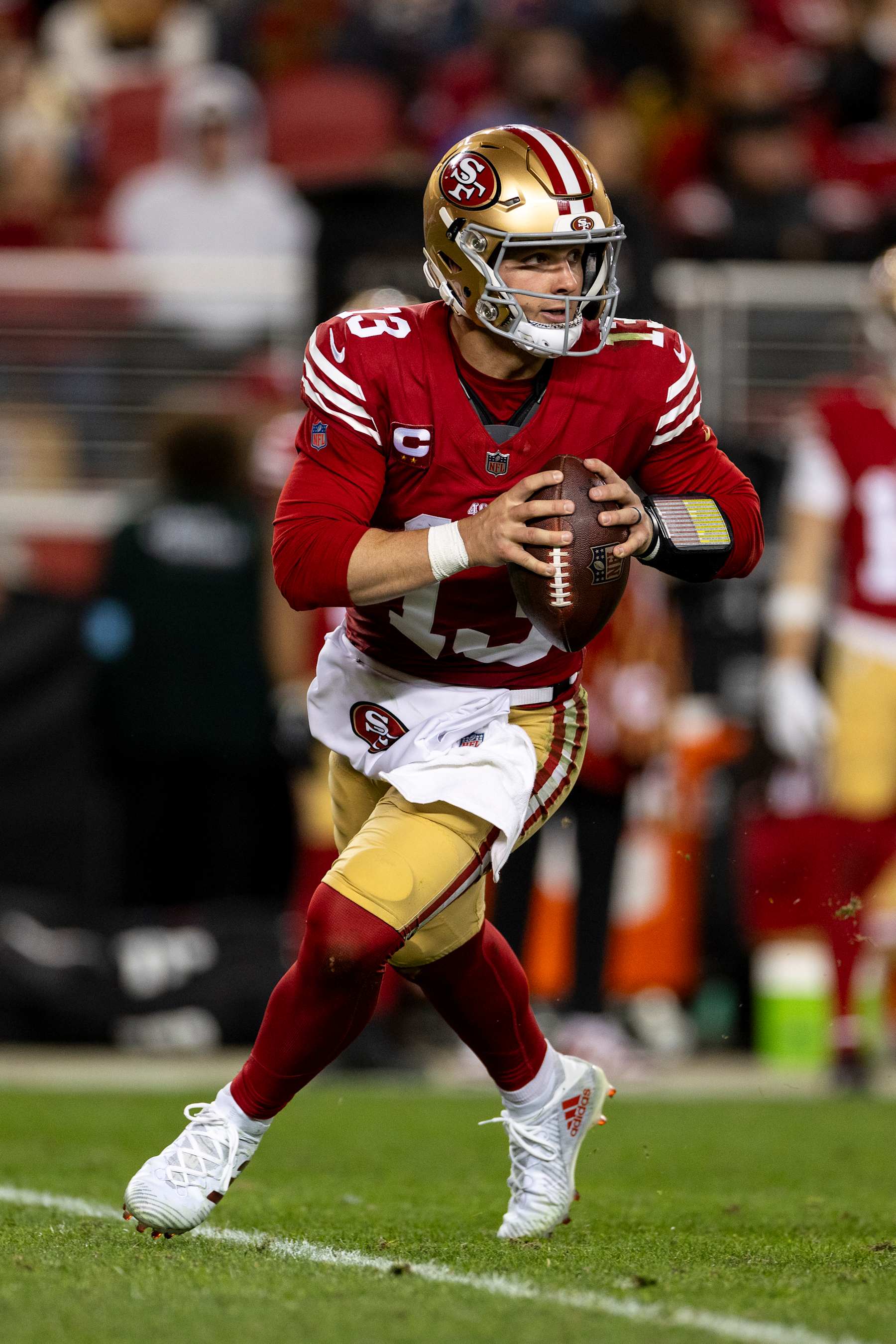 SANTA CLARA, CALIFORNIA - DECEMBER 30: Brock Purdy #13 of the San Francisco 49ers scrambles and looks to pass during an NFL Football game against the Detroit Lions at Levi's Stadium on December 30, 2024 in Santa Clara, California. (Photo by Michael Owens/Getty Images)