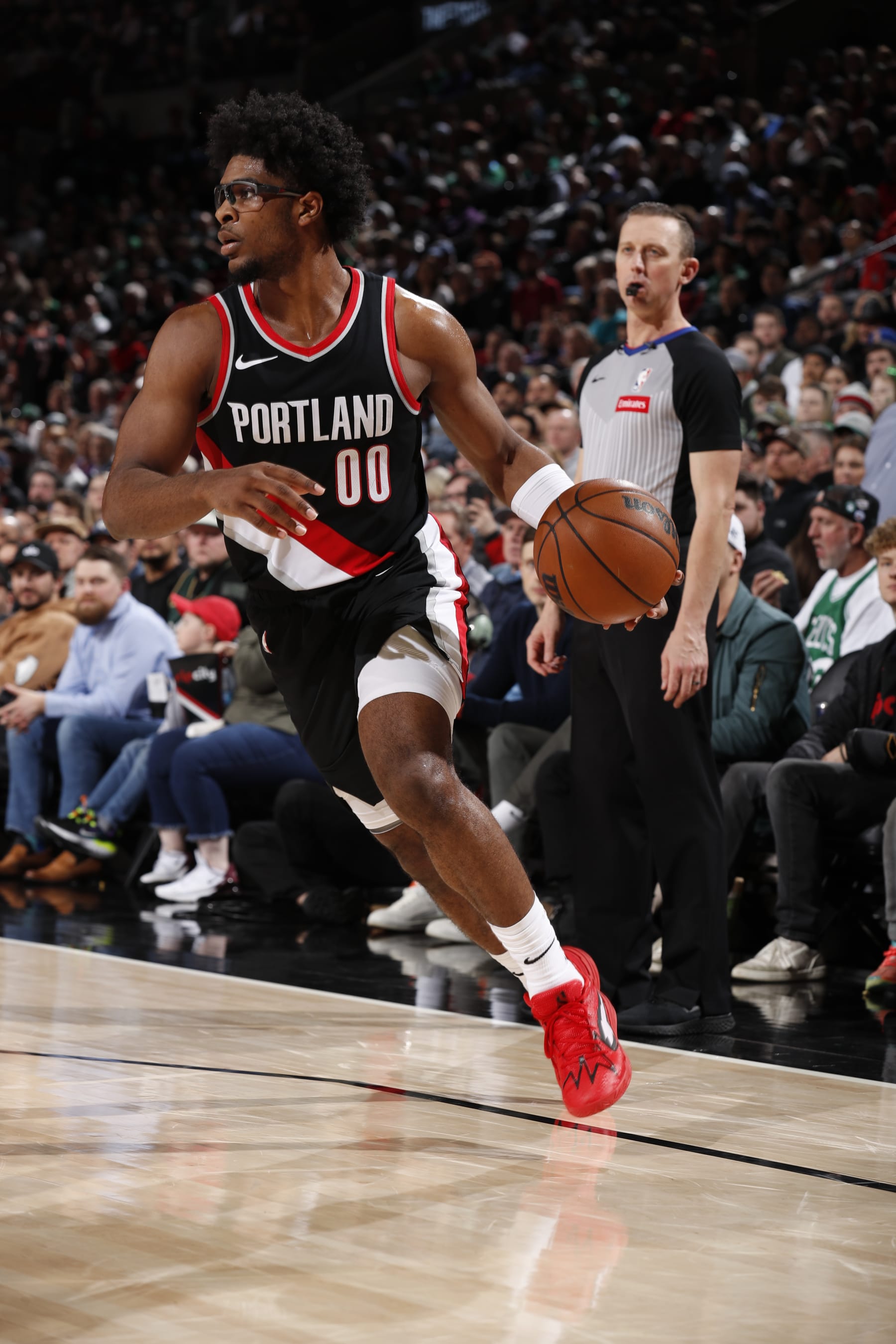 PORTLAND, OR - MARCH 11: Scoot Henderson #00 of the Portland Trail Blazers handles the ball during the game against the Boston Celtics on March 11, 2024 at the Moda Center Arena in Portland, Oregon. NOTE TO USER: User expressly acknowledges and agrees that, by downloading and or using this photograph, user is consenting to the terms and conditions of the Getty Images License Agreement. Mandatory Copyright Notice: Copyright 2024 NBAE (Photo by Cameron Browne/NBAE via Getty Images)
