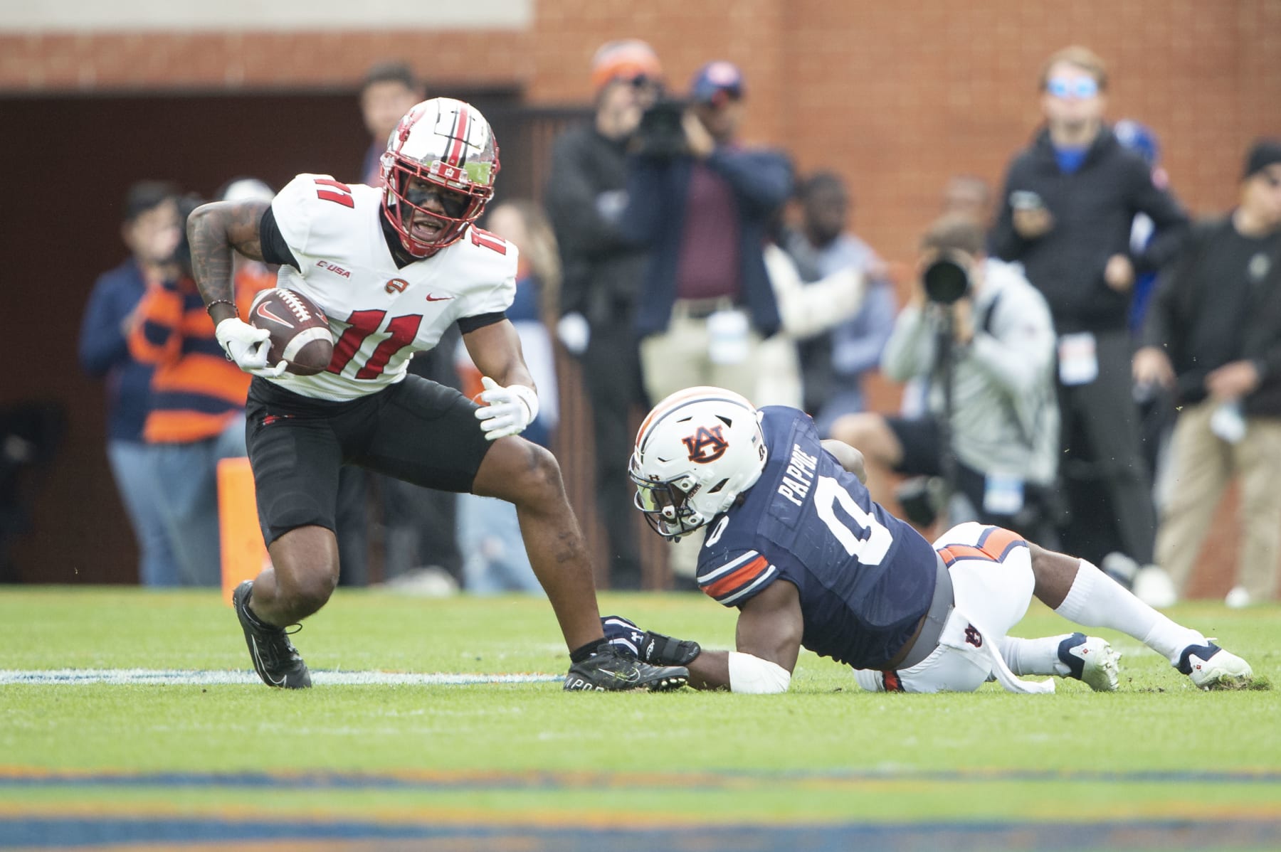 AUBURN, ALABAMA - NOVEMBER 19: Wide receiver Malachi Corley #11 of the Western Kentucky Hilltoppers maneuvers the ball by linebacker Owen Pappoe #0 of the Auburn Tigers during the first half of play at Jordan-Hare Stadium on November 19, 2022 in Auburn, Alabama. (Photo by Michael Chang/Getty Images)