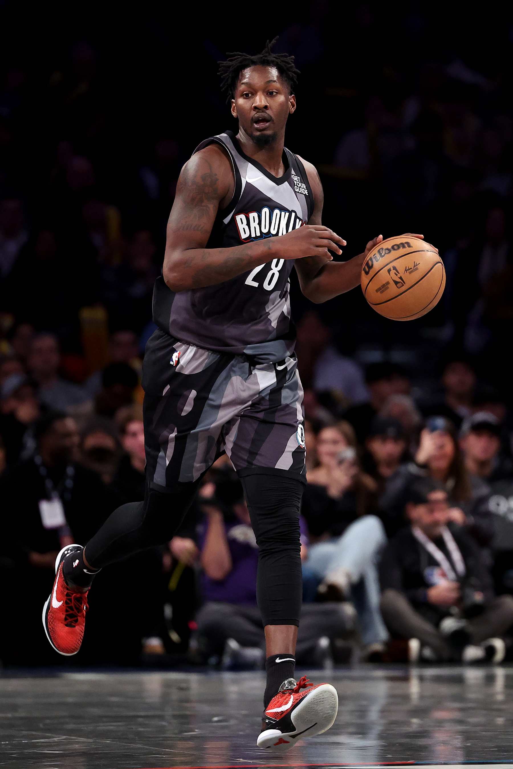 NEW YORK, NEW YORK - DECEMBER 27: Dorian Finney-Smith #28 of the Brooklyn Nets dribbles the ball against the San Antonio Spurs during the second half at Barclays Center on December 27, 2024 in New York City. NOTE TO USER: User expressly acknowledges and agrees that, by downloading and or using this photograph, User is consenting to the terms and conditions of the Getty Images License Agreement.  (Photo by Luke Hales/Getty Images)