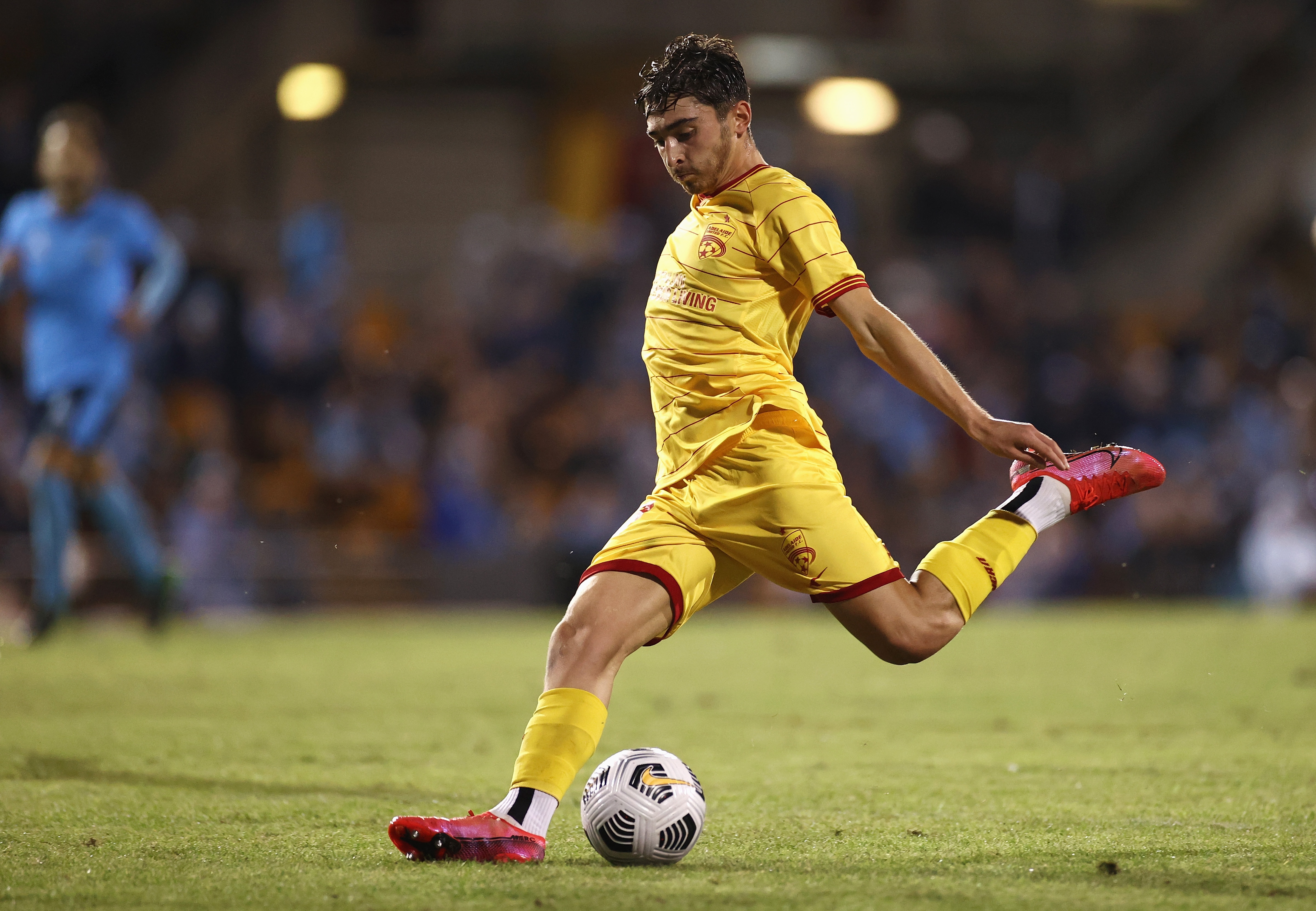 SYDNEY, AUSTRALIA - APRIL 18: Josh Cavallo of United kicks during the A-League match between Sydney FC and Adelaide United at Leichhardt Oval, on April 18, 2021, in Sydney, Australia. (Photo by Cameron Spencer/Getty Images)