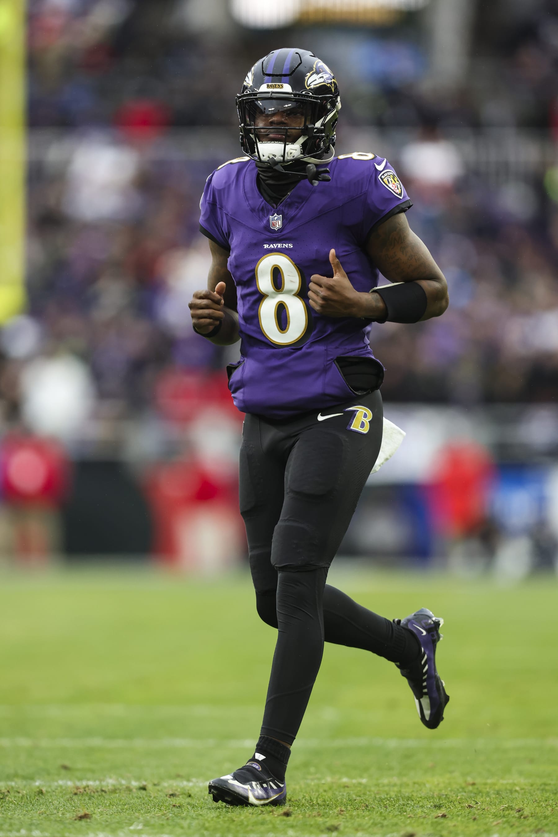 BALTIMORE, MD - JANUARY 28: Lamar Jackson #8 of the Baltimore Ravens runs across the field during the AFC Championship NFL football game against the Kansas City Chiefs at M&T Bank Stadium on January 28, 2024 in Baltimore, Maryland. (Photo by Perry Knotts/Getty Images)