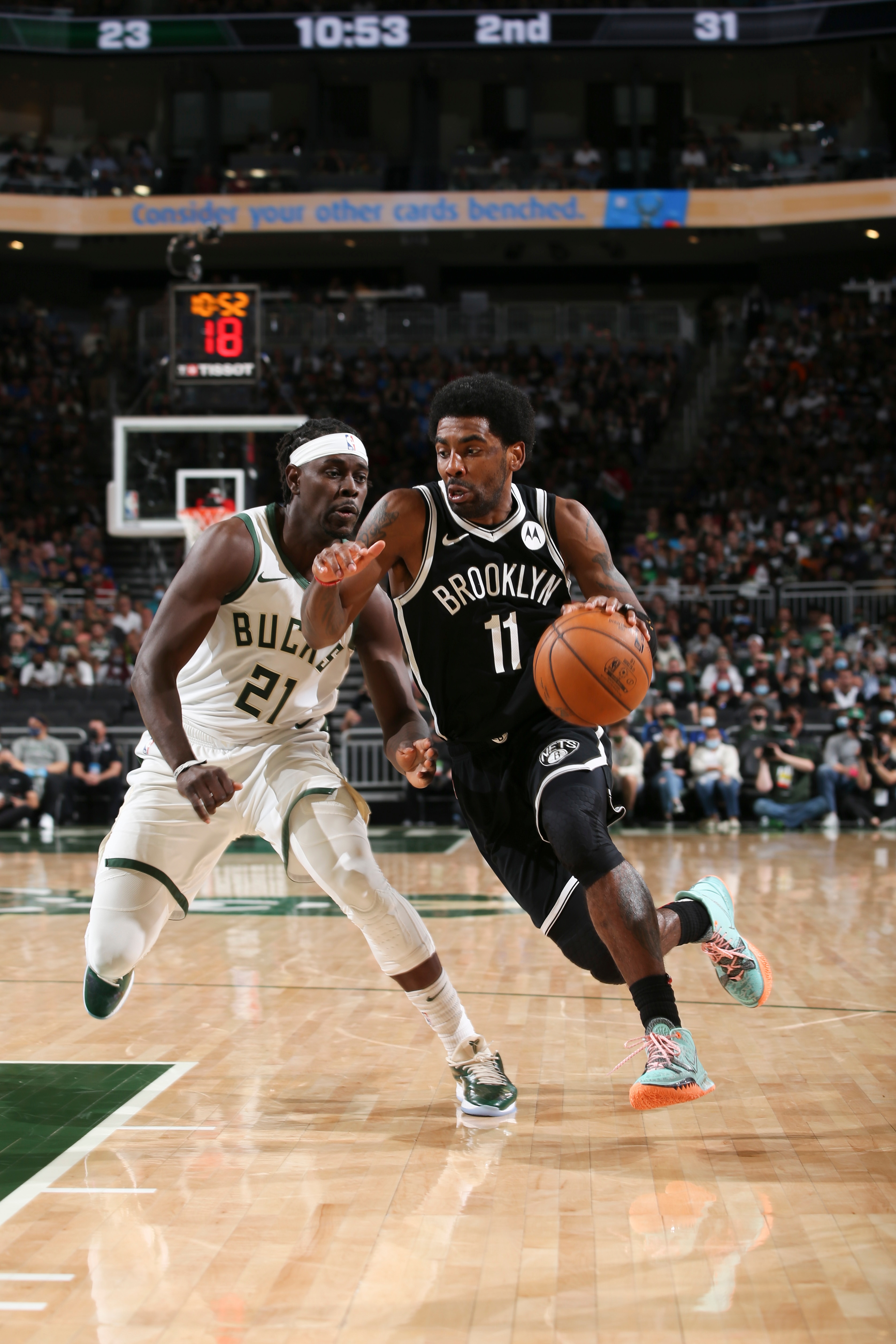 MILWAUKEE, WI - JUNE 13: Jrue Holiday #21 of the Milwaukee Bucks plays defense as Kyrie Irving #11 of the Brooklyn Nets handles the ball during the game during Round 2, Game 4 of the 2021 NBA Playoffs  on June 13, 2021 at the Fiserv Forum Center in Milwaukee, Wisconsin. NOTE TO USER: User expressly acknowledges and agrees that, by downloading and or using this Photograph, user is consenting to the terms and conditions of the Getty Images License Agreement. Mandatory Copyright Notice: Copyright 2021 NBAE (Photo by Gary Dineen/NBAE via Getty Images).