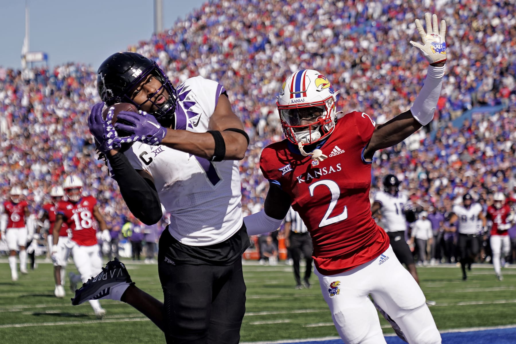 TCU wide receiver Quentin Johnston (1) catches the game-winning touchdown under pressure from Kansas cornerback Cobee Bryant during the second half of an NCAA college football game Saturday, Oct. 8, 2022, in Lawrence, Kan. TCU won 38-31. (AP Photo/Charlie Riedel)