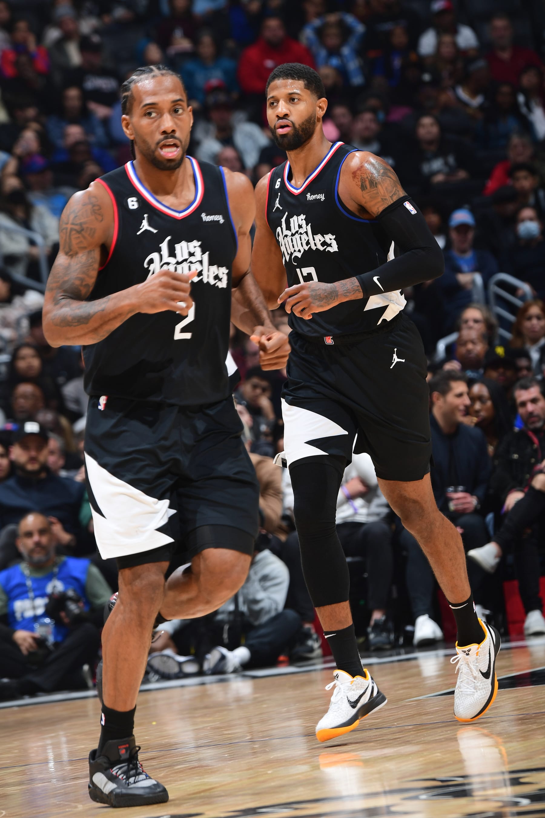 LOS ANGELES, CA - JANUARY 26: Kawhi Leonard #2 and Paul George #13 of the LA Clippers look on against the San Antonio Spurs on January 26, 2023 at Crypto.Com Arena in Los Angeles, California. NOTE TO USER: User expressly acknowledges and agrees that, by downloading and/or using this Photograph, user is consenting to the terms and conditions of the Getty Images License Agreement. Mandatory Copyright Notice: Copyright 2023 NBAE (Photo by Adam Pantozzi/NBAE via Getty Images)