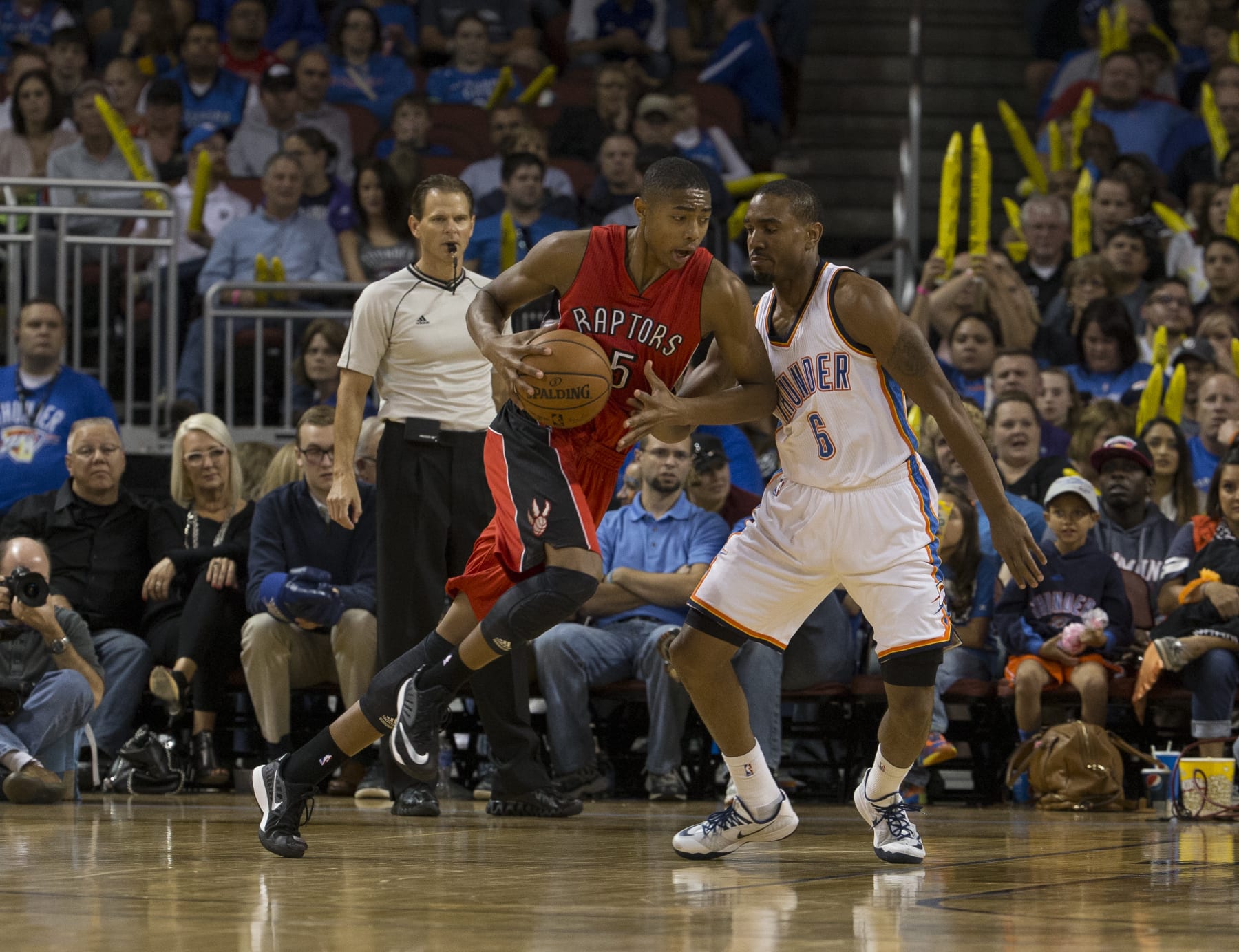 WICHITA KS - OCTOBER 17:  Bruno Caboclo #5 of the Toronto Raptors handles the ball against Michael Jenkins #6 of the Oklahoma City Thunder on October 17, 2014 at the Intrust Bank Arena in Wichita, Kansas. NOTE TO USER:  User expressly acknowledges and agrees that, by downloading and/or using this photograph, user is consenting to the terms and conditions of the Getty Images License Agreement. Mandatory Copyright Notice:  Copyright 2014 NBAE (Photo by Richard Rowe/NBAE via Getty Images)