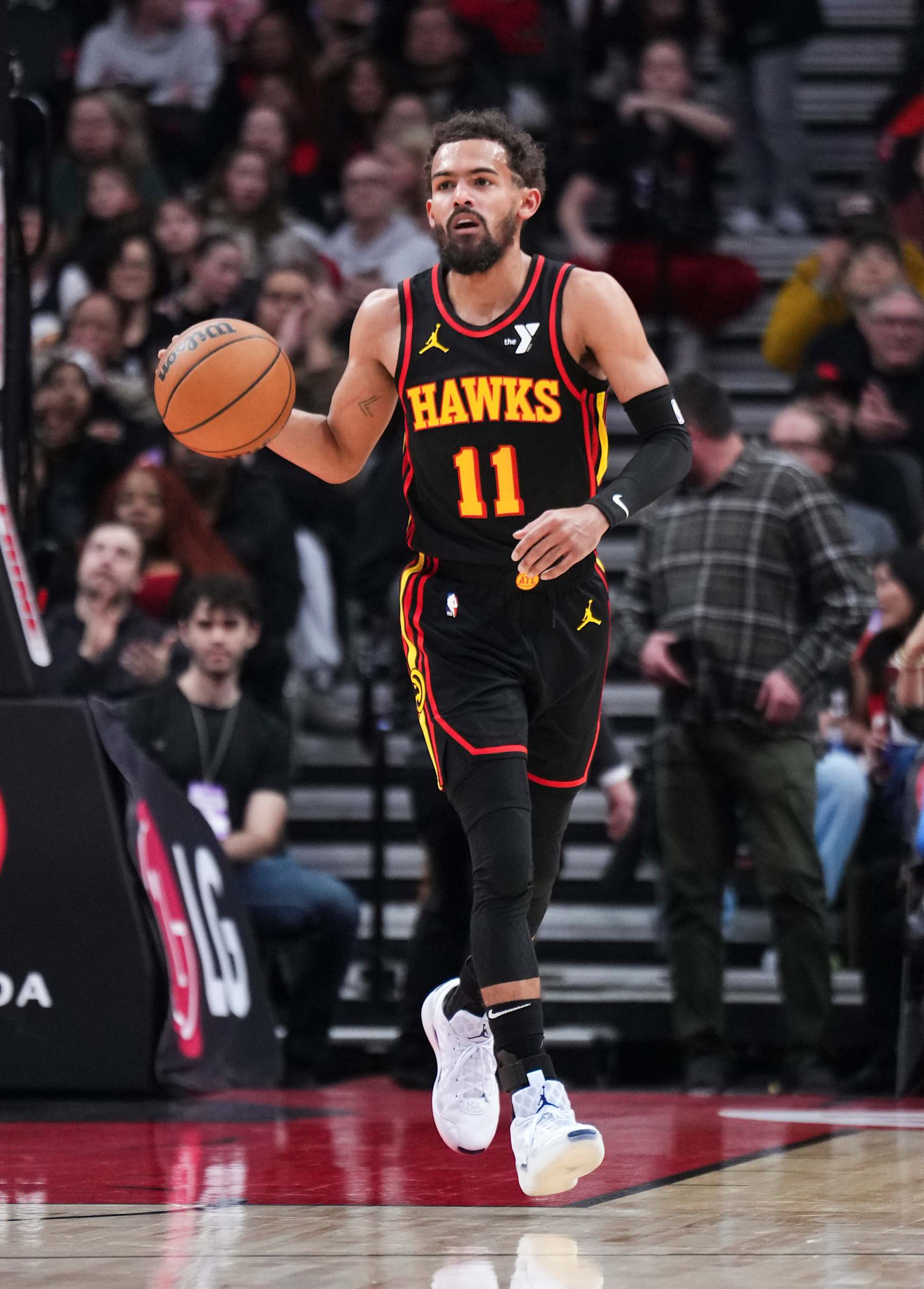 TORONTO, ON - DECEMBER 29: Trae Young #11 of the Atlanta Hawks dribbles against the Toronto Raptors during the first half of their basketball game at the Scotiabank Arena on December 29, 2024 in Toronto, Ontario, Canada. NOTE TO USER: User expressly acknowledges and agrees that, by downloading and/or using this Photograph, user is consenting to the terms and conditions of the Getty Images License Agreement. (Photo by Mark Blinch/Getty Images)