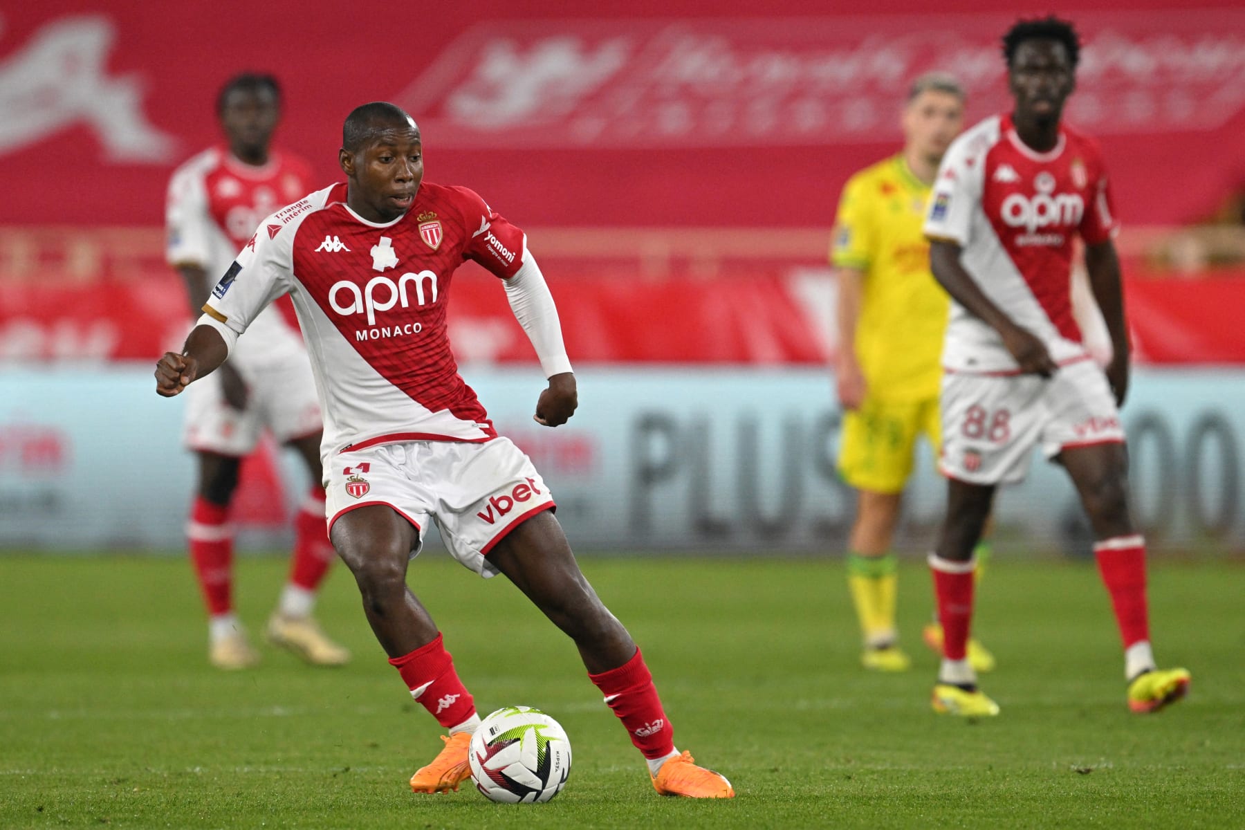 Monaco's Malian midfielder #04 Mohamed Camara (L) passes the ball during the French L1 football match between AS Monaco and FC Nantes at the Louis II Stadium (Stade Louis II) in the Principality of Monaco on May 19, 2024. (Photo by Nicolas TUCAT / AFP) (Photo by NICOLAS TUCAT/AFP via Getty Images)