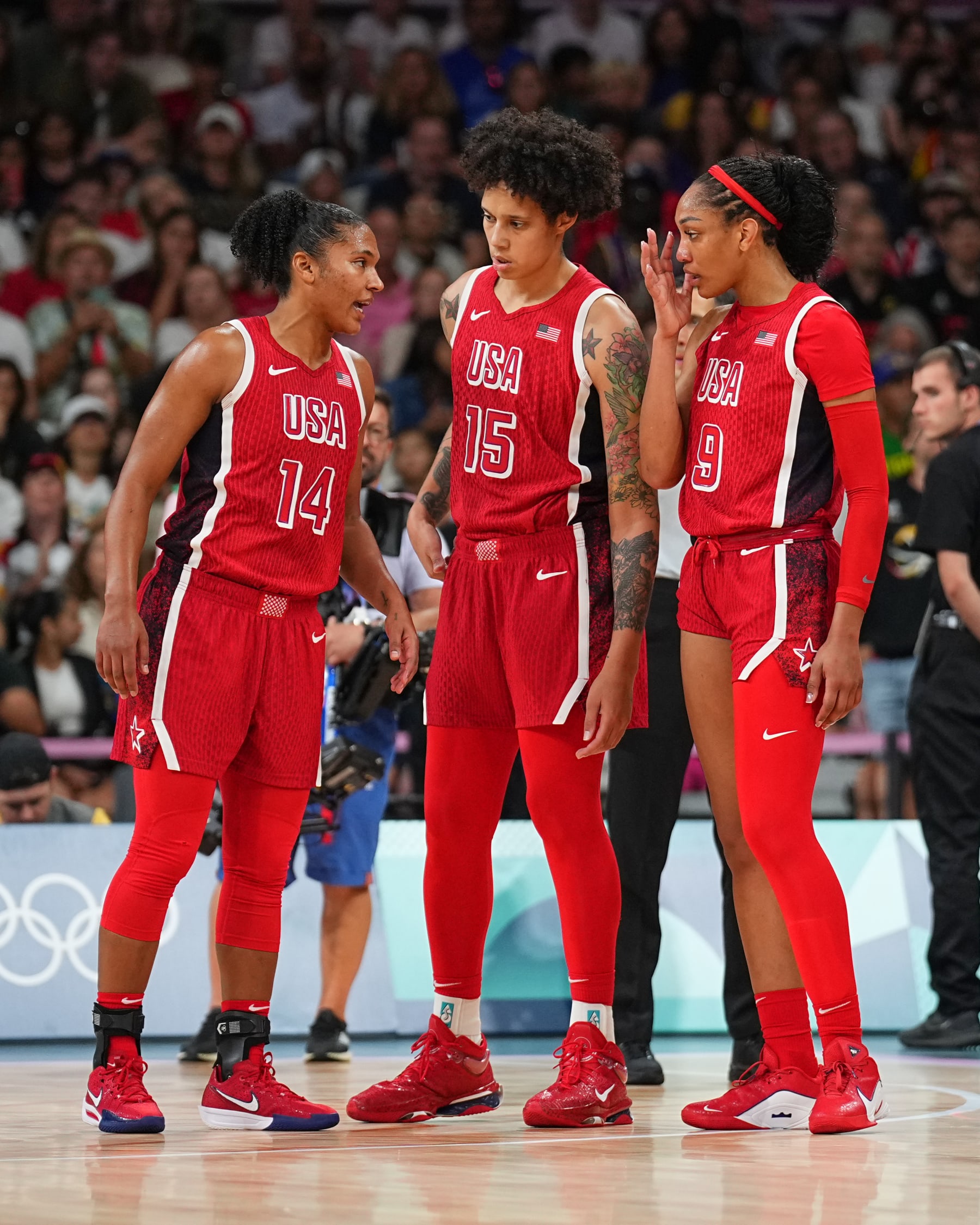 LILLE, FRANCE - AUGUST 4:   Alyssa Thomas #14 of Team USA Brittney Griner #15 of Team USA and A'ja Wilson #9 of Team USA looks on during the game at the  Stade Pierre Mauroy on August 4, 2024 in Lille, France. NOTE TO USER: User expressly acknowledges and agrees that, by downloading and/or using this photograph, user is consenting to the terms and conditions of the Getty Images License Agreement. Mandatory Copyright Notice: Copyright 2024 NBAE (Photo by Garrett W. Ellwood/NBAE via Getty Images)