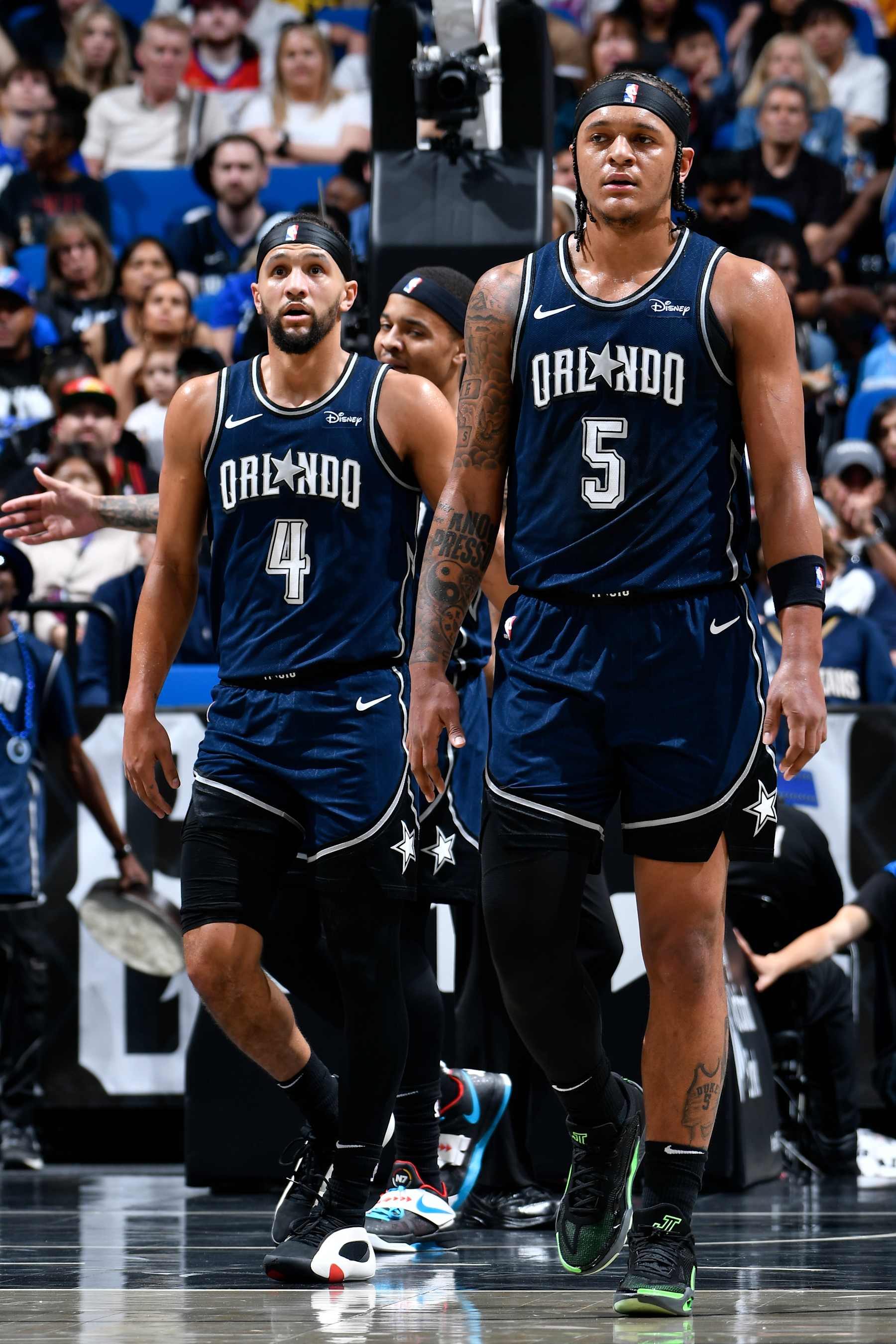 ORLANDO, FL - MARCH 21: Jalen Suggs #4 and Paolo Banchero #5 of the Orlando Magic look on during the game against the New Orleans Pelicans on March 21, 2024 at Amway Center in Orlando, Florida. NOTE TO USER: User expressly acknowledges and agrees that, by downloading and or using this photograph, User is consenting to the terms and conditions of the Getty Images License Agreement. Mandatory Copyright Notice: Copyright 2024 NBAE (Photo by Fernando Medina/NBAE via Getty Images)