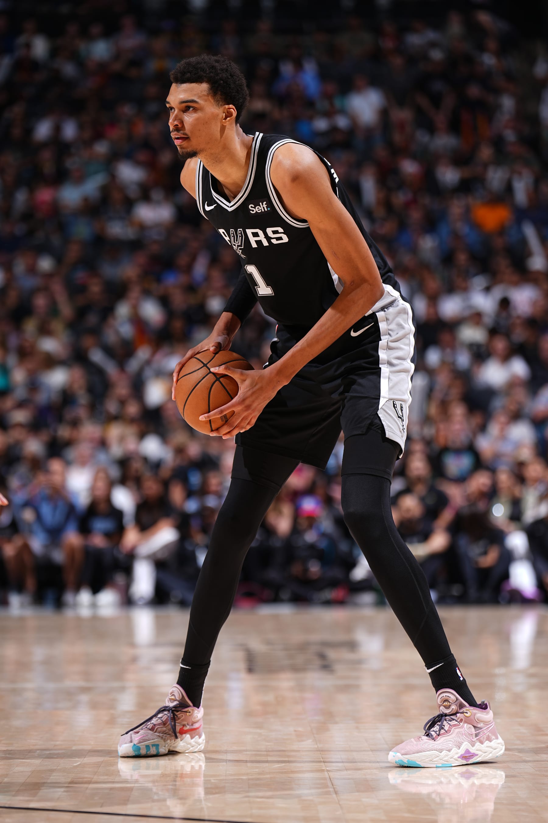 SAN ANTONIO, TX - APRIL 12: Victor Wembanyama #1 of the San Antonio Spurs looks to pass the ball during the game against the Denver Nuggets on April 12, 2024 at the Frost Bank Center in San Antonio, Texas. NOTE TO USER: User expressly acknowledges and agrees that, by downloading and or using this photograph, user is consenting to the terms and conditions of the Getty Images License Agreement. Mandatory Copyright Notice: Copyright 2024 NBAE (Photos by Garrett Ellwood/NBAE via Getty Images)