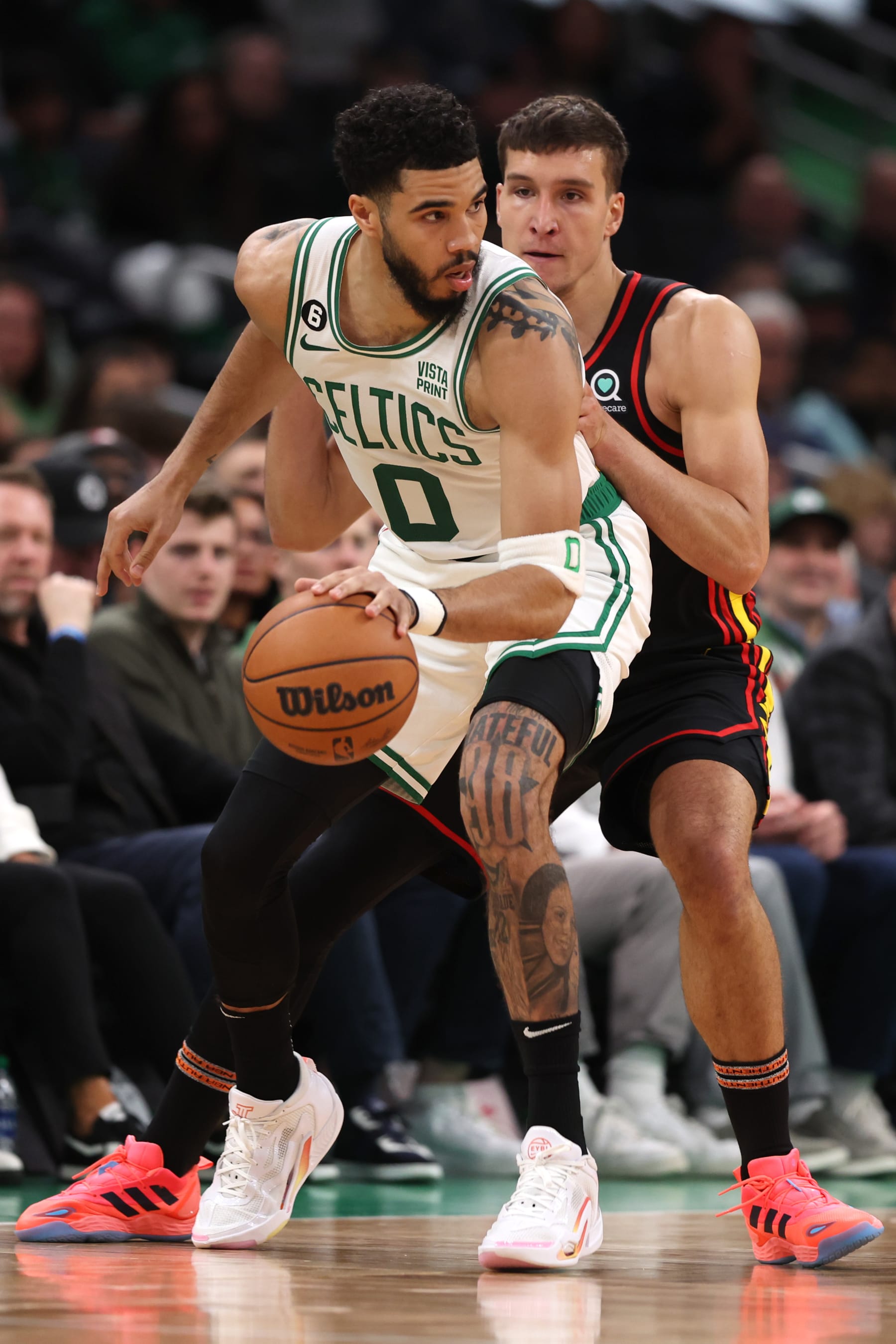 BOSTON, MASSACHUSETTS - APRIL 18: Bogdan Bogdanovic #13 of the Atlanta Hawks defends Jayson Tatum #0 of the Boston Celtics during the second quarter of Game Two of the Eastern Conference First Round Playoffs between the Boston Celtics and the Atlanta Hawks at TD Garden on April 18, 2023 in Boston, Massachusetts. NOTE TO USER: User expressly acknowledges and agrees that, by downloading and or using this photograph, User is consenting to the terms and conditions of the Getty Images License Agreement.  (Photo by Maddie Meyer/Getty Images)