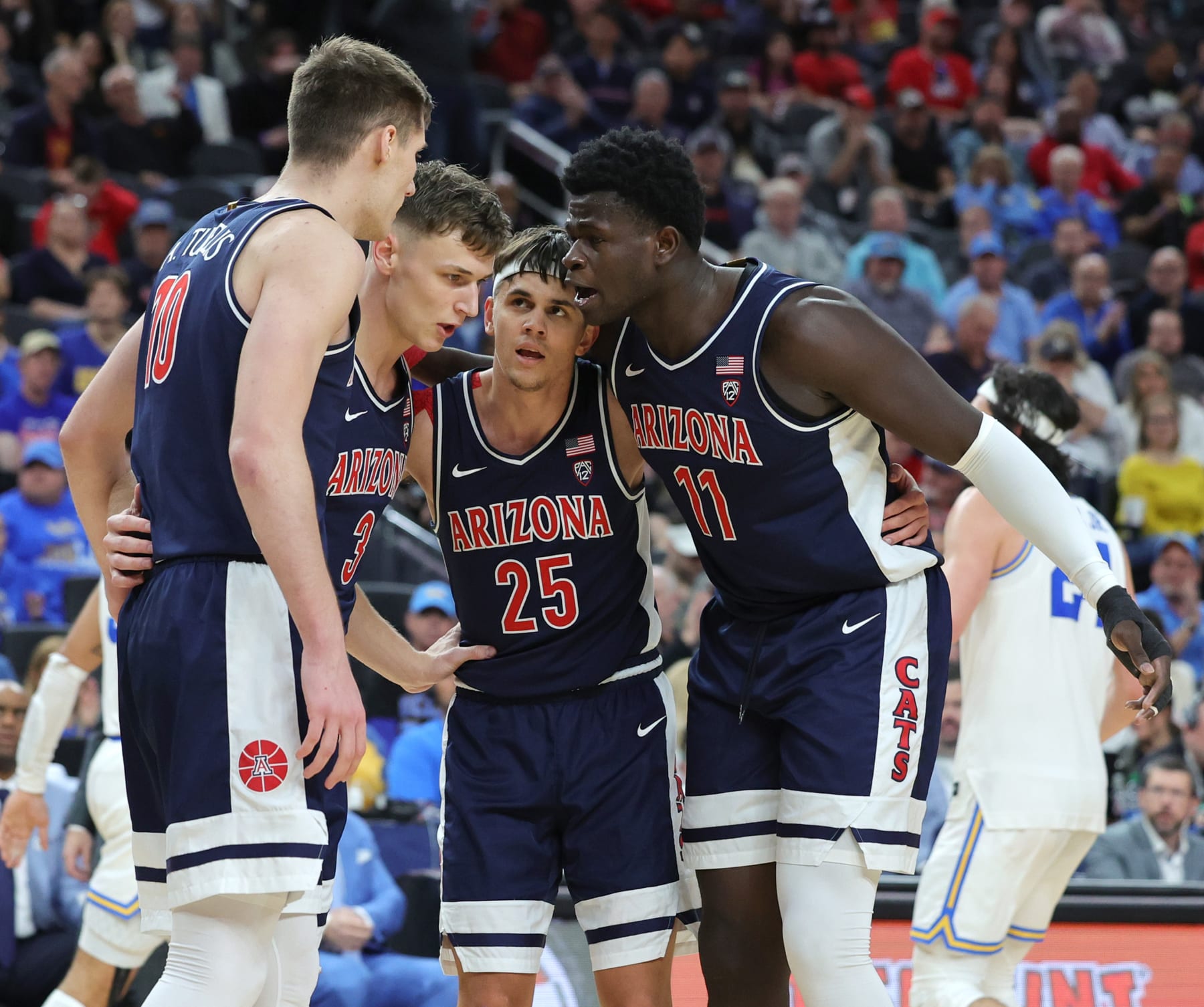 LAS VEGAS, NEVADA - MARCH 11: Azuolas Tubelis #10, Pelle Larsson #3, Kerr Kriisa #25 and Oumar Ballo #11 of the Arizona Wildcats huddle on the court during a break in the second half of the championship game of the Pac-12 basketball tournament against the UCLA Bruins at T-Mobile Arena on March 11, 2023 in Las Vegas, Nevada. The Wildcats defeated the Bruins 61-59. (Photo by Ethan Miller/Getty Images)