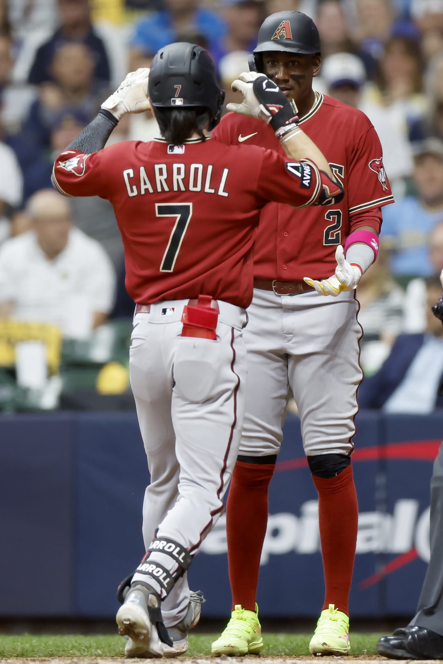 MILWAUKEE, WISCONSIN - OCTOBER 03: Corbin Carroll #7 and Geraldo Perdomo #2 of the Arizona Diamondbacks celebrate after Carroll hit a home run in the third inning against the Milwaukee Brewers during Game One of the Wild Card Series at American Family Field on October 03, 2023 in Milwaukee, Wisconsin. (Photo by John Fisher/Getty Images)