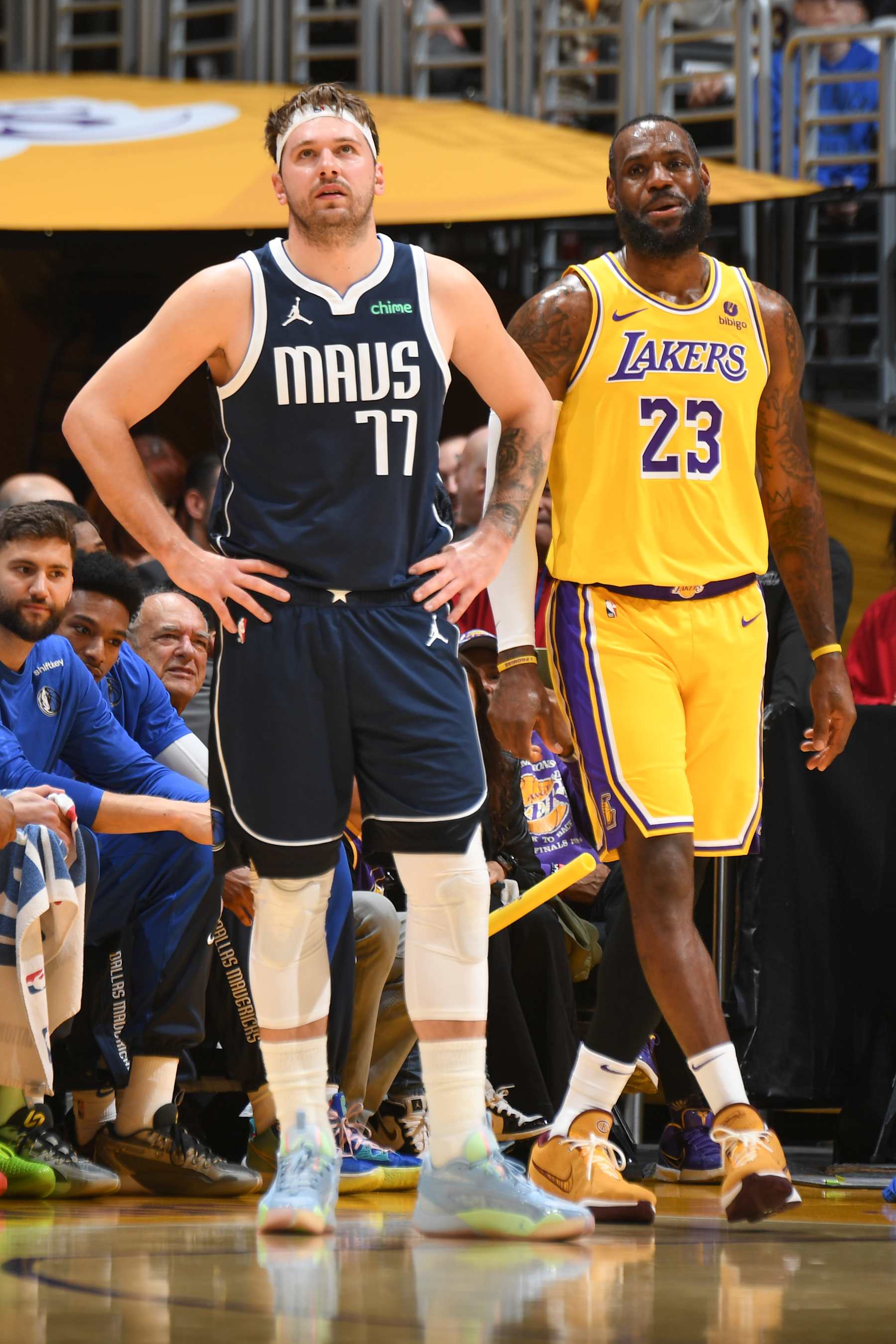 LOS ANGELES, CA - JANUARY 17:  Luka Doncic #77 of the Dallas Mavericks & LeBron James #23 of the Los Angeles Lakers look on during the game on January 17, 2024 at Crypto.Com Arena in Los Angeles, California. NOTE TO USER: User expressly acknowledges and agrees that, by downloading and/or using this Photograph, user is consenting to the terms and conditions of the Getty Images License Agreement. Mandatory Copyright Notice: Copyright 2024 NBAE (Photo by Andrew D. Bernstein/NBAE via Getty Images)