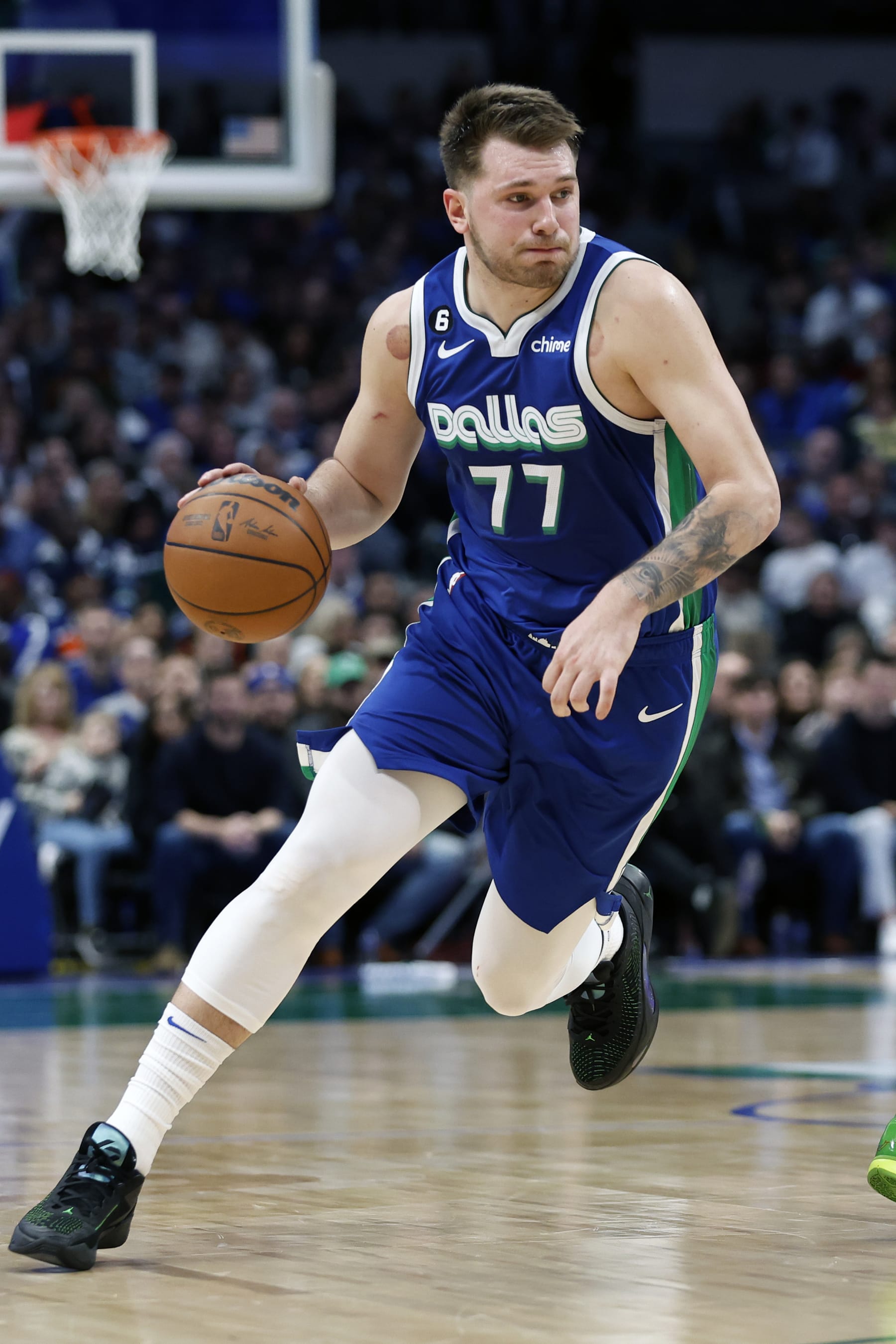 DALLAS, TEXAS - DECEMBER 27:  Luka Doncic #77 of the Dallas Mavericks dribbles the ball up court against the New York Knicks in the second half at American Airlines Center on December 27, 2022 in Dallas, Texas. NOTE TO USER: User expressly acknowledges and agrees that, by downloading and or using this photograph, User is consenting to the terms and conditions of the Getty Images License Agreement.  (Photo by Tim Heitman/Getty Images)