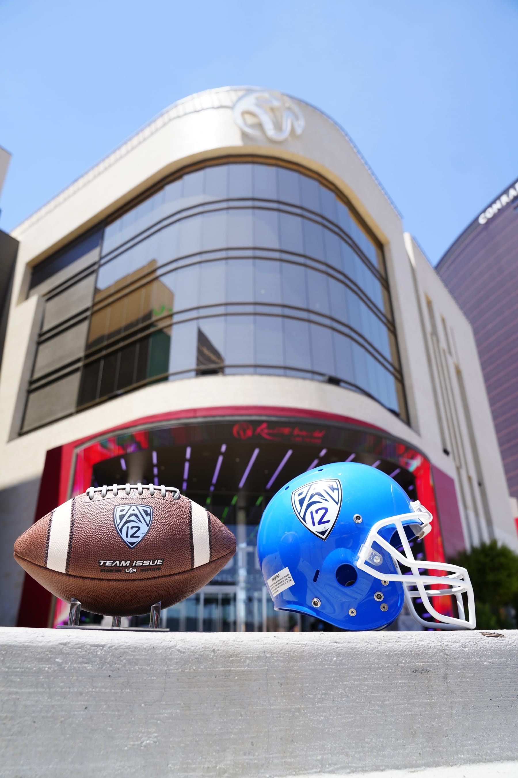 LAS VEGAS, NEVADA - JULY 21: the Pac-12 helmet and official game ball on display in front of Resorts World for Pac-12 Media Day at Zouk Nightclub at Resorts World Las Vegas on July 21, 2023 in Las Vegas, Nevada. (Photo by Louis Grasse/Getty Images)