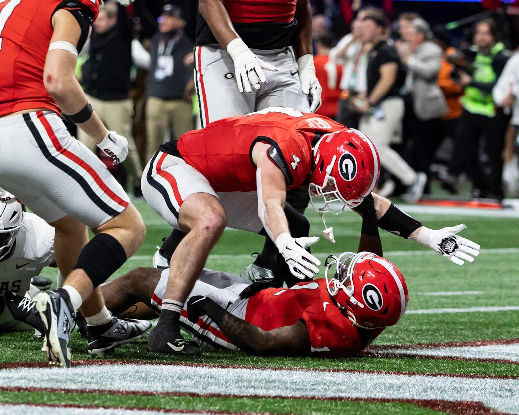 ATLANTA, GEORGIA - DECEMBER 7: Oscar Delp #4 of the Georgia Bulldogs congratulates Trevor Etienne #1 after he scored the winning touchdown during the 2024 SEC Championship game between the Georgia Bulldogs and the Texas Longhorns at Mercedes-Benz Stadium on December 7, 2024 in Atlanta, Georgia. (Photo by Steve Limentani/ISI Photos/Getty Images)